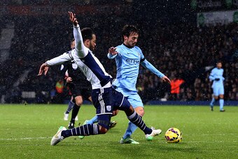 WEST BROMWICH, ENGLAND - DECEMBER 26:  Joleon Lescott of West Brom fouls David Silva of Manchester City and concedes a penalty during the Barclays Premier League match between West Bromwich Albion and Manchester City at The Hawthorns on December 26, 2014 