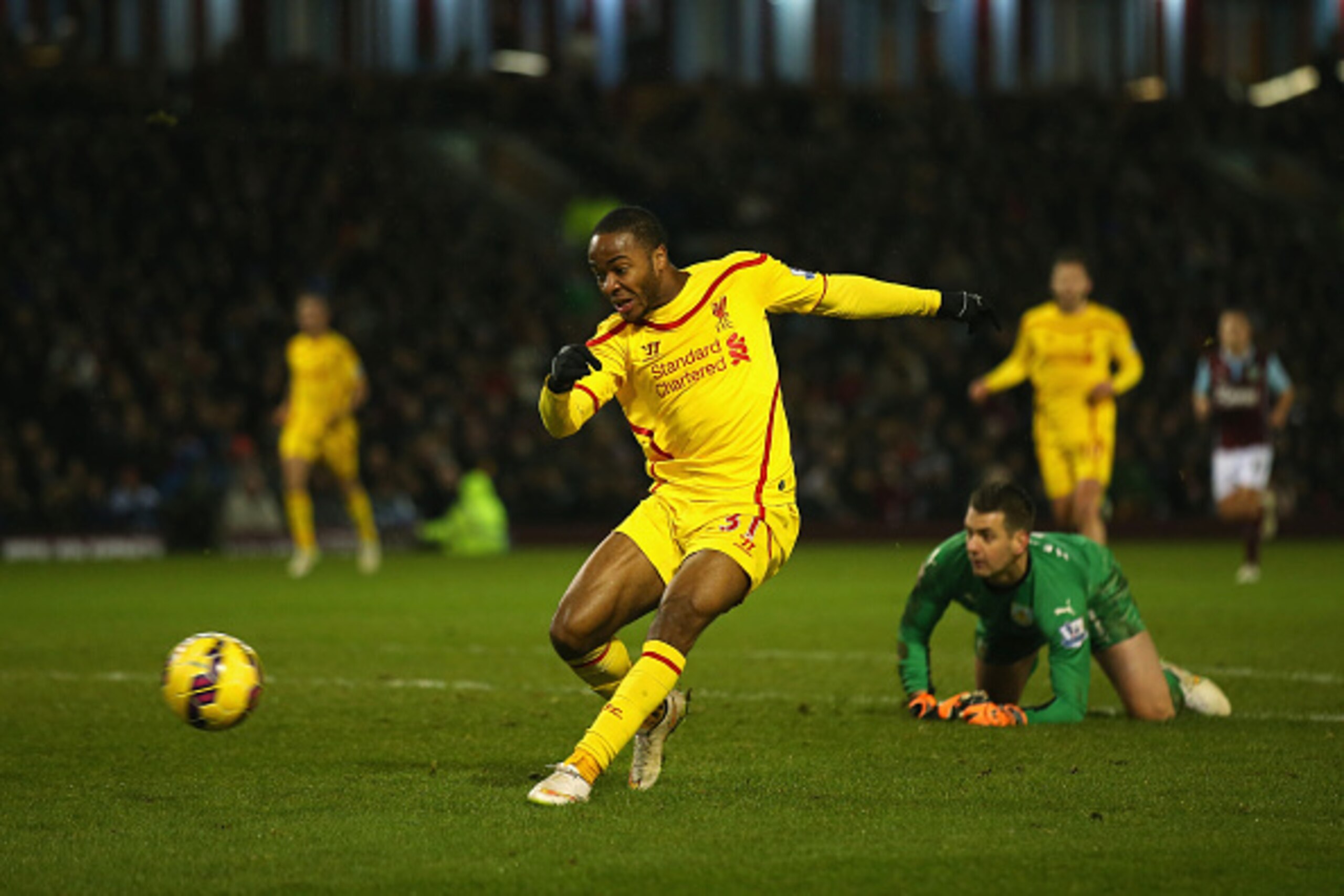BURNLEY, ENGLAND - DECEMBER 26:  Raheem Sterling of Liverpool scores the opening goal during the Barclays Premier League match between Burnley and Liverpool at Turf Moor on December 26, 2014 in Burnley, England.  (Photo by Bryn Lennon/Getty Images)
