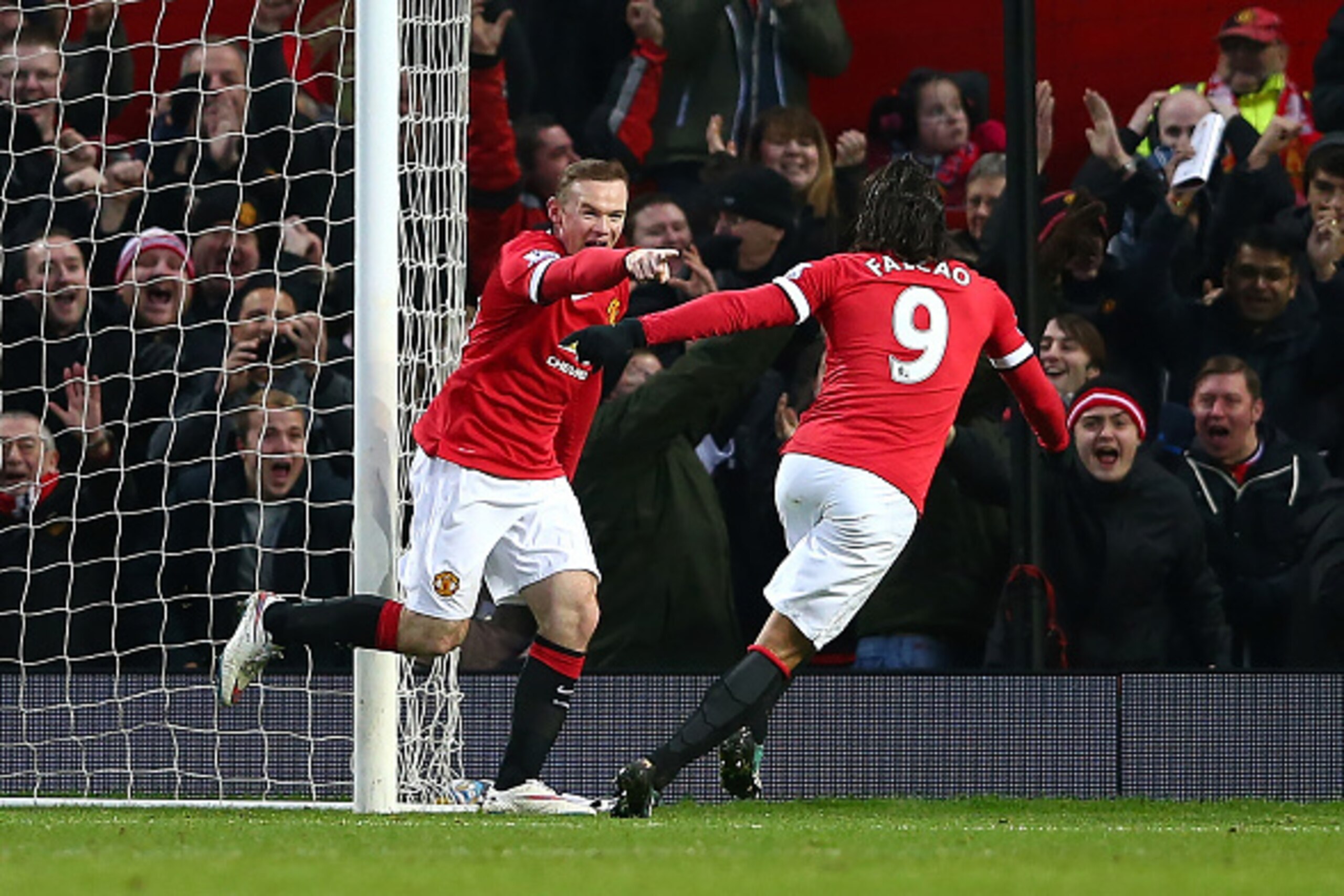 MANCHESTER, ENGLAND - DECEMBER 26:  Wayne Rooney of Manchester United celebrates scoring the first goal with team-mate Radamel Falcao (R) during the Barclays Premier League match between Manchester United and Newcastle United at Old Trafford on December 2