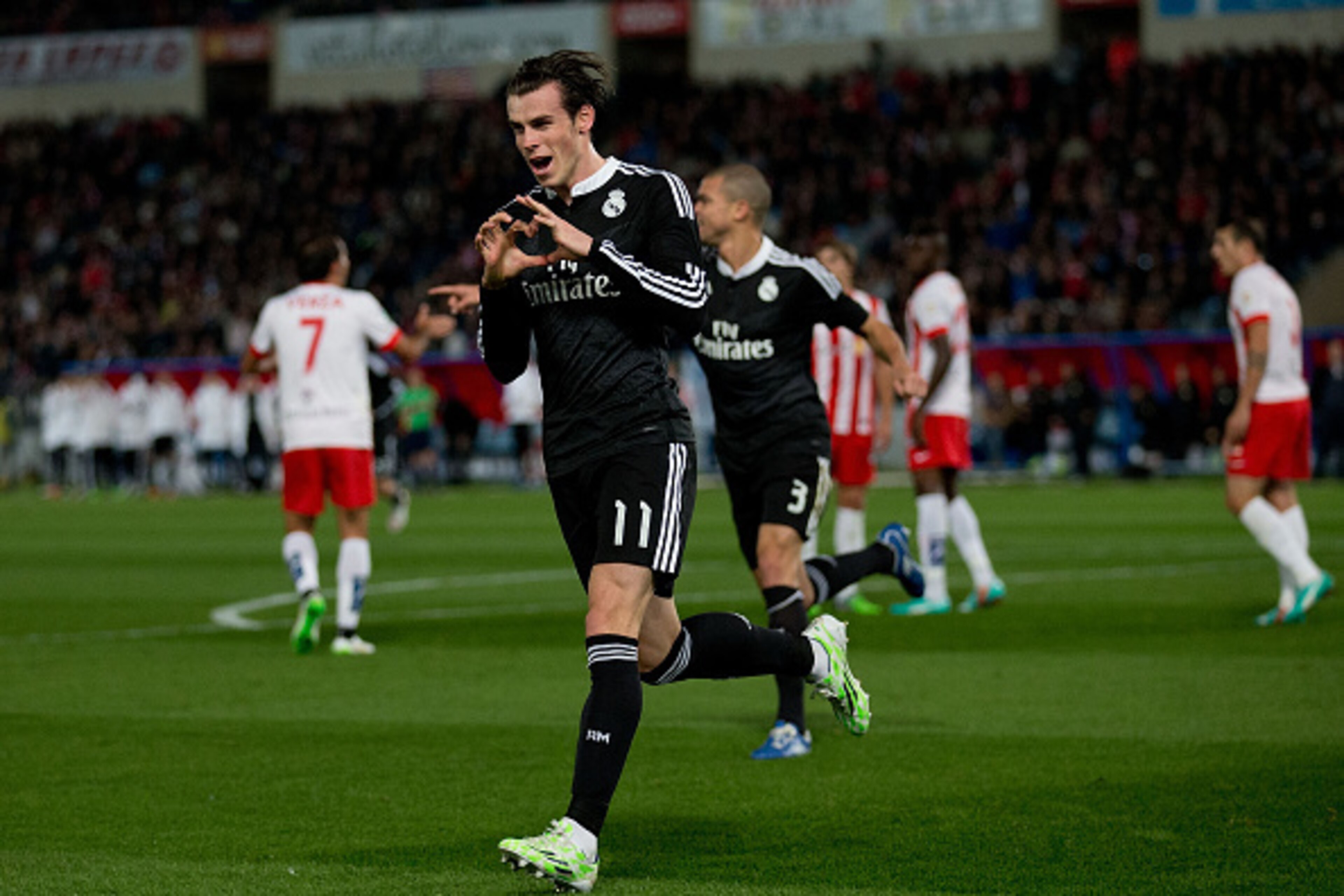 ALMERIA, SPAIN - DECEMBER 12:  Gareth Bale of Real Madrid CF celebrates scoring their second goal during the La Liga match between UD Almeria and Real Madrid CF at Juegos del Mediterraneo stadium on December 12, 2014 in Almeria, Spain.  (Photo by Gonzalo 