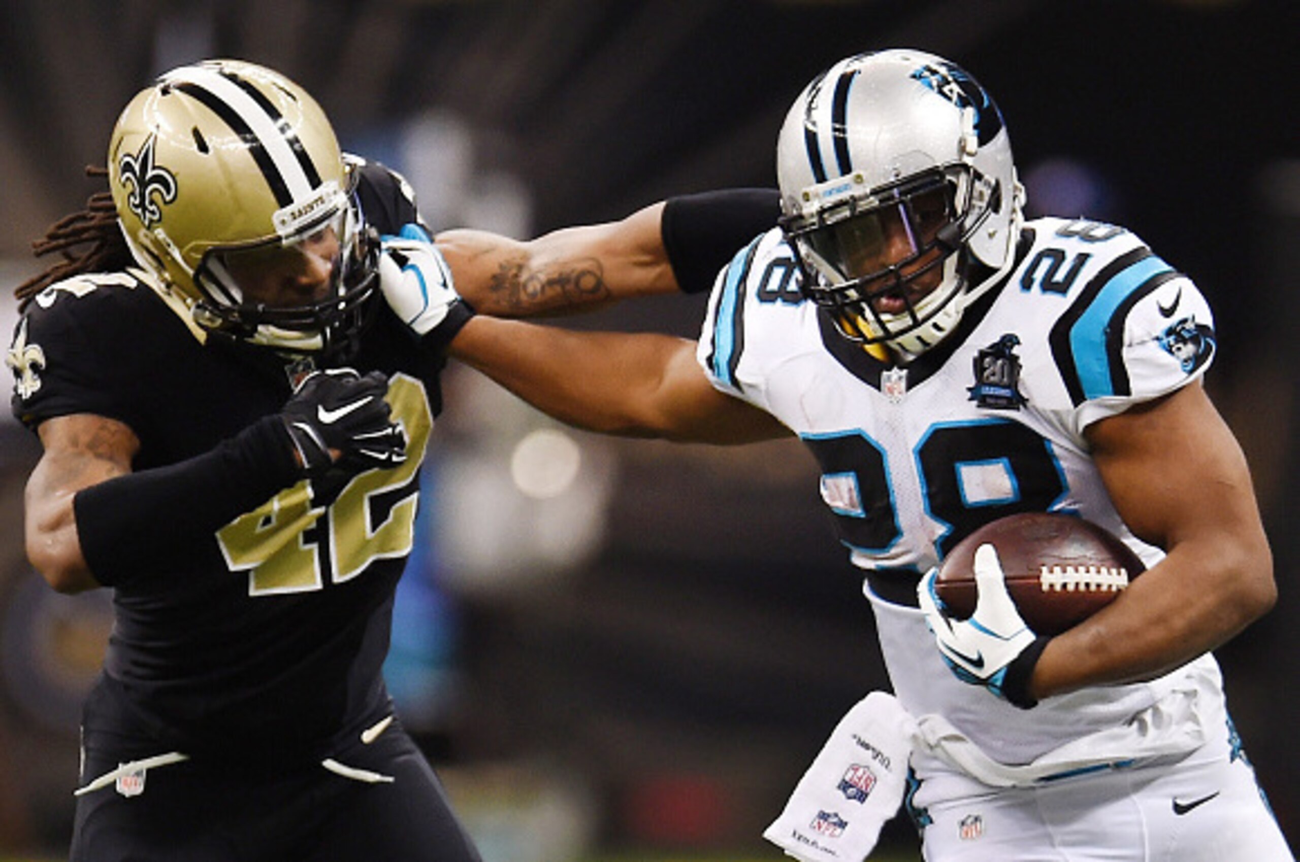 NEW ORLEANS, LA - DECEMBER 07:  Jonathan Stewart #28 of the Carolina Panthers runs the ball as  Pierre Warren #42 of the New Orleans Saints defends during the first quarter at Mercedes-Benz Superdome on December 7, 2014 in New Orleans, Louisiana.  (Photo 