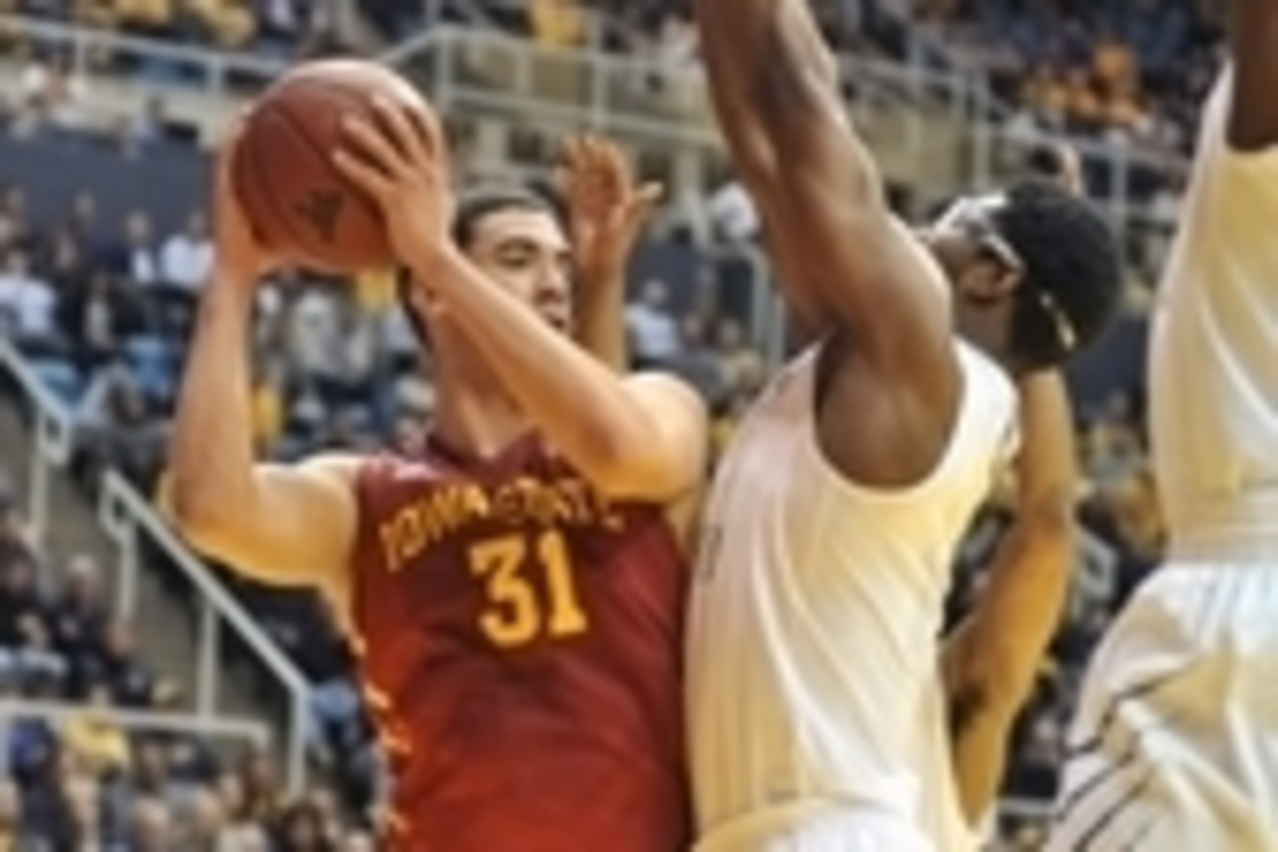 Feb 10, 2014; Morgantown, WV, USA; Iowa State Cyclones forward Georges Niang (31) being guarded by West Virginia Mountaineers forward Devin Williams (5) at WVU Coliseum. Mandatory Credit: Dan Friend-USA TODAY Sports West Virginia Wins 102 - 77