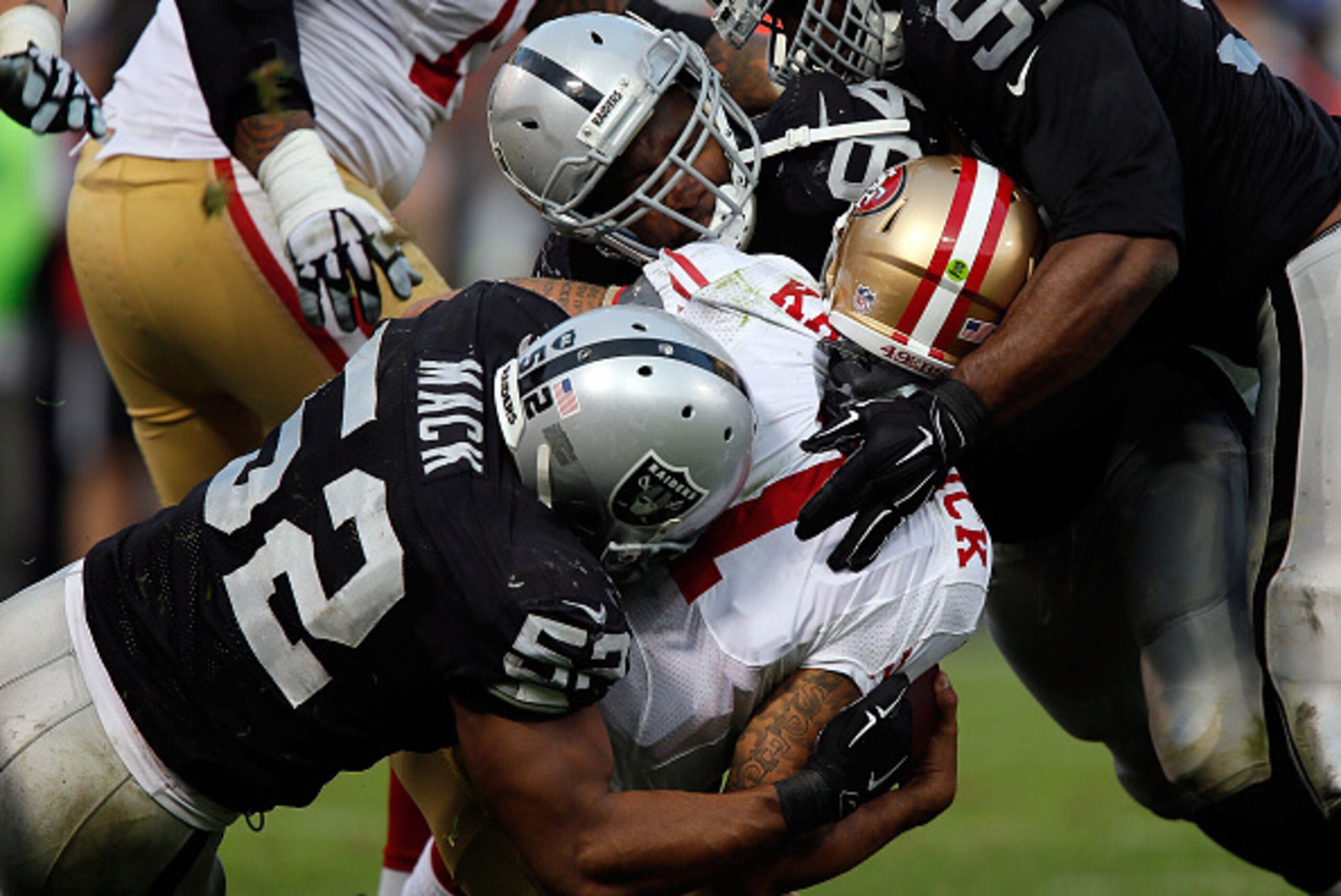 OAKLAND, CA - DECEMBER 07:  Justin Tuck #91 of the Oakland Raiders, Antonio Smith #94 of the Oakland Raiders, Khalil Mack #52 of the Oakland Raiders sack Colin Kaepernick #7 of the San Francisco 49ers in the fourth quarter at O.co Coliseum on December 7, 
