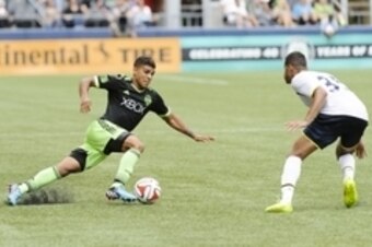 Jul 19, 2014; Seattle, WA, USA; Seattle Sounders FC defender DeAndre Yedlin (17) dribbles the ball while being defended by Tottenham Hotspur defender Ezekiel Fryers (35) during he second half at CenturyLink Field. The game was a 3-3 draw. Mandatory Credit