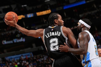 DENVER, CO - DECEMBER 14:  Kawhi Leonard #2 of the San Antonio Spurs controls the ball against Ty Lawson #3 of the Denver Nuggets at Pepsi Center on December 14, 2014 in Denver, Colorado. The Spurs defeated the Nuggets 99-91. NOTE TO USER: User expressly 