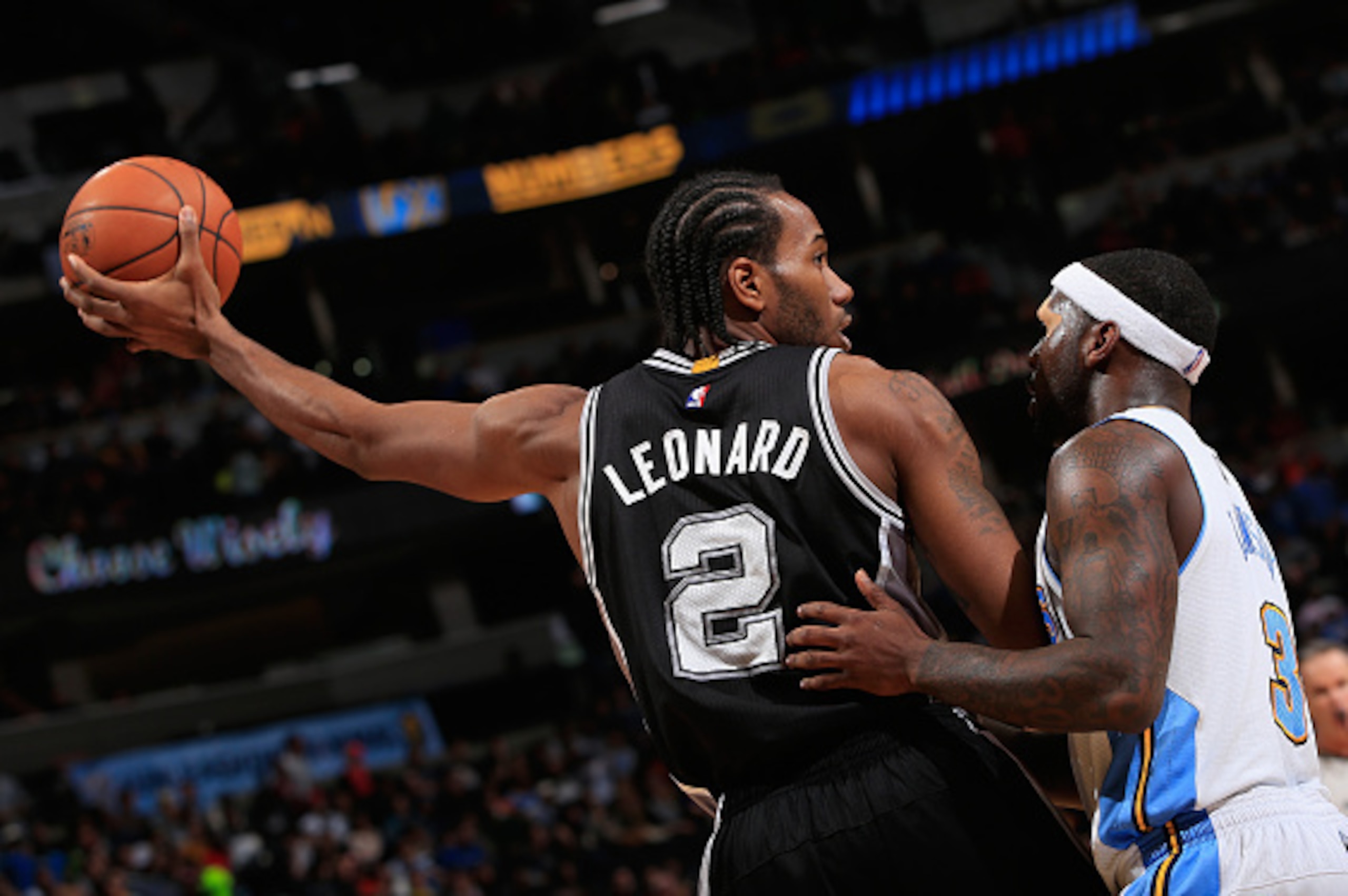 DENVER, CO - DECEMBER 14:  Kawhi Leonard #2 of the San Antonio Spurs controls the ball against Ty Lawson #3 of the Denver Nuggets at Pepsi Center on December 14, 2014 in Denver, Colorado. The Spurs defeated the Nuggets 99-91. NOTE TO USER: User expressly 