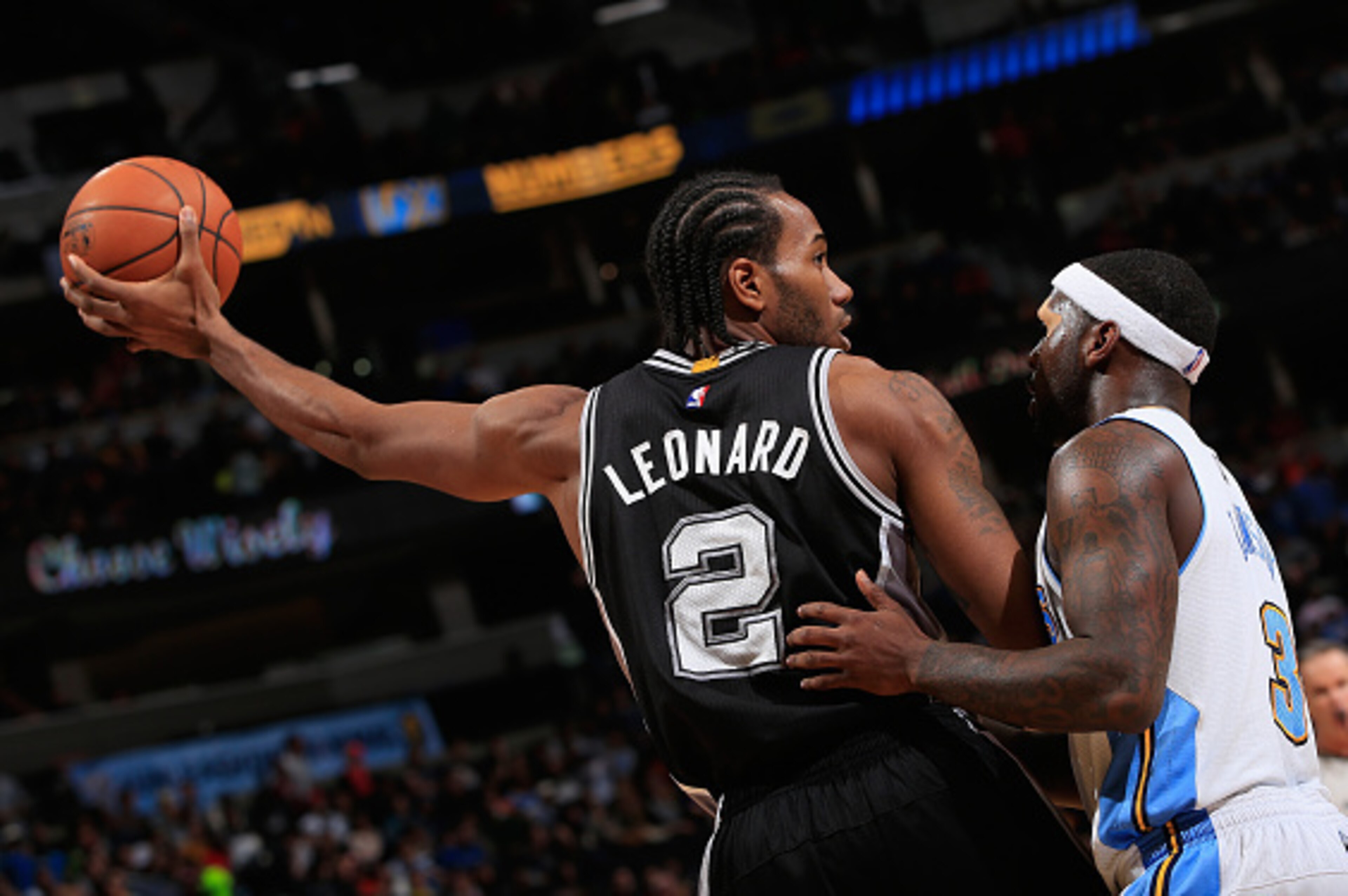 DENVER, CO - DECEMBER 14:  Kawhi Leonard #2 of the San Antonio Spurs controls the ball against Ty Lawson #3 of the Denver Nuggets at Pepsi Center on December 14, 2014 in Denver, Colorado. The Spurs defeated the Nuggets 99-91. NOTE TO USER: User expressly 