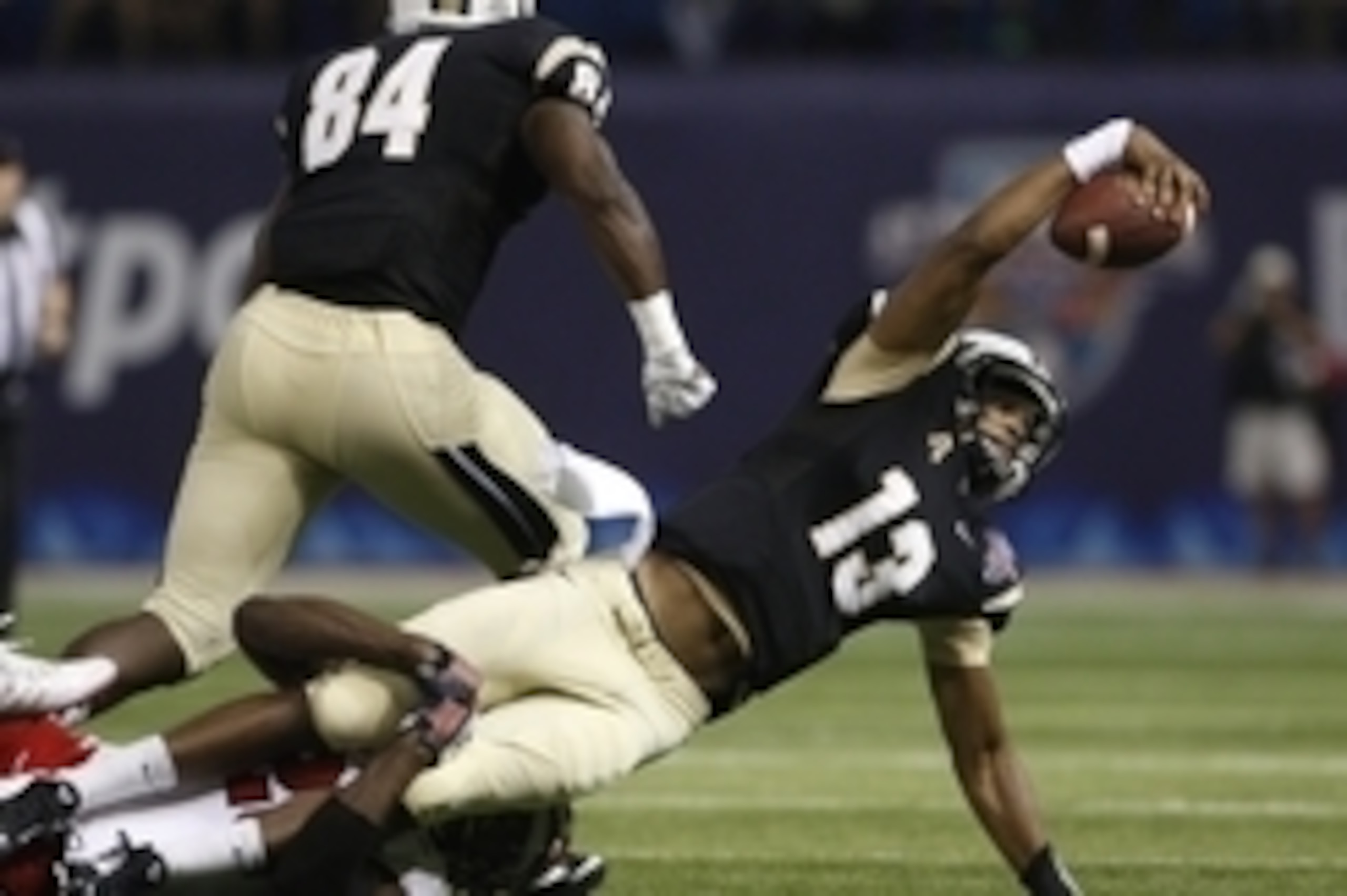 Dec 26, 2014; St. Petersburg, FL, USA; Central Florida Knights quarterback Justin Holman (13) dives for a first down against the North Carolina State Wolfpack during the first half in the 2014 St. Petersburg Bowl at Tropicana Field. Mandatory Credit: Mark