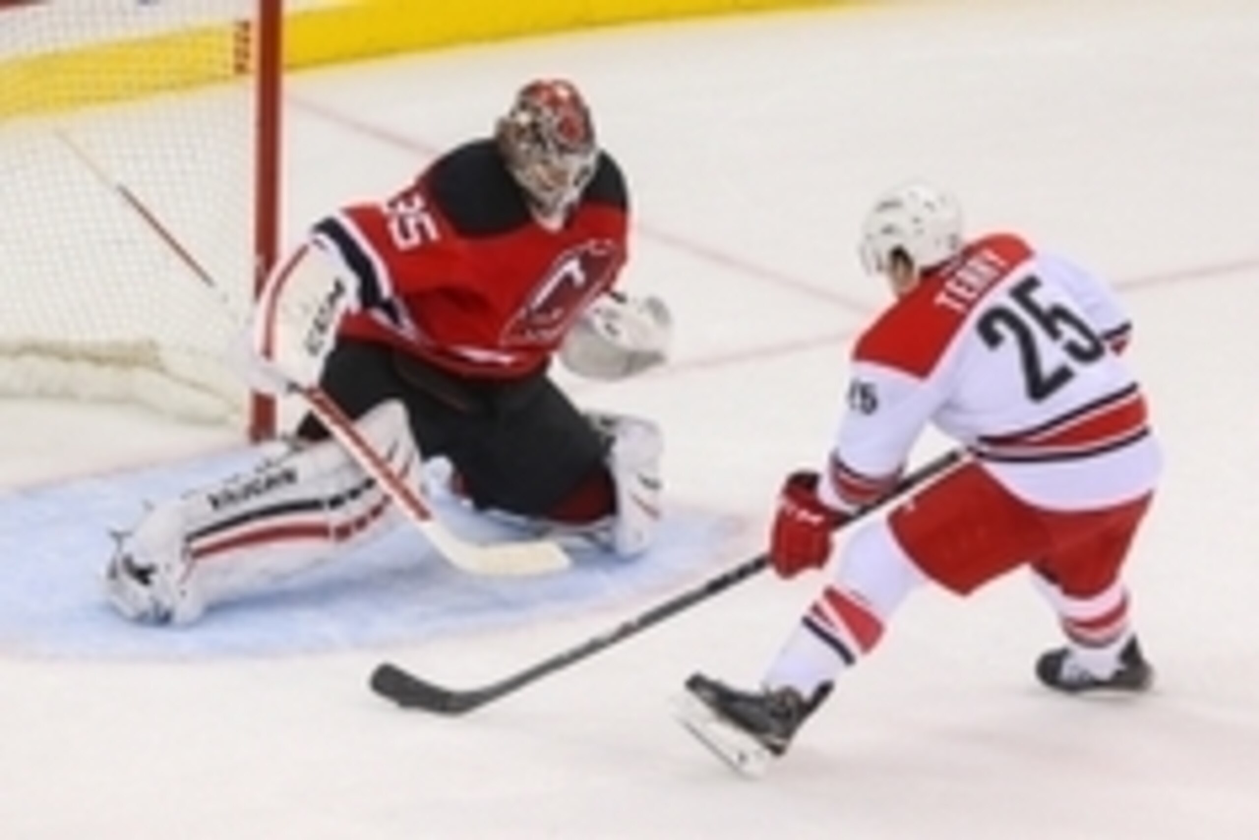 Dec 23, 2014; Newark, NJ, USA; Carolina Hurricanes left wing Chris Terry (25) scores the game winning goal on New Jersey Devils goalie Cory Schneider (35) during the shootout at Prudential Center. The Hurricanes defeated the Devils 2-1.  Mandatory Credit: