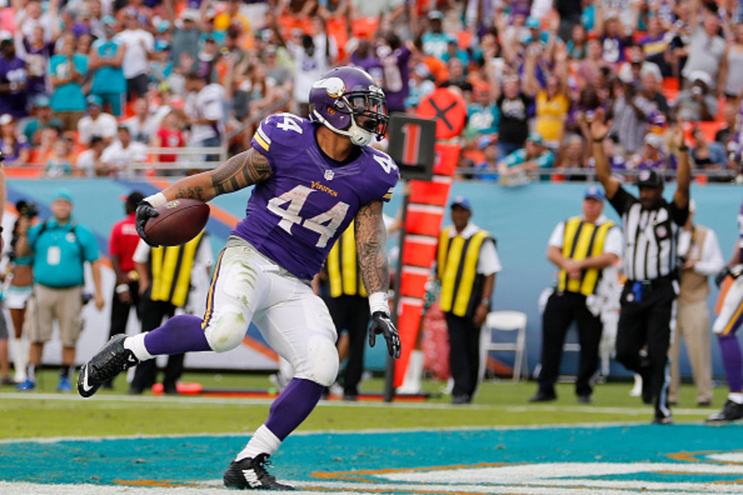 MIAMI GARDENS, FL - DECEMBER 21:  Running back Matt Asiata #44 of the Minnesota Vikings runs in the end zone as he scored a fourth quarter touchdown during a game against the Miami Dolphins at Sun Life Stadium on December 21, 2014 in Miami Gardens, Florid