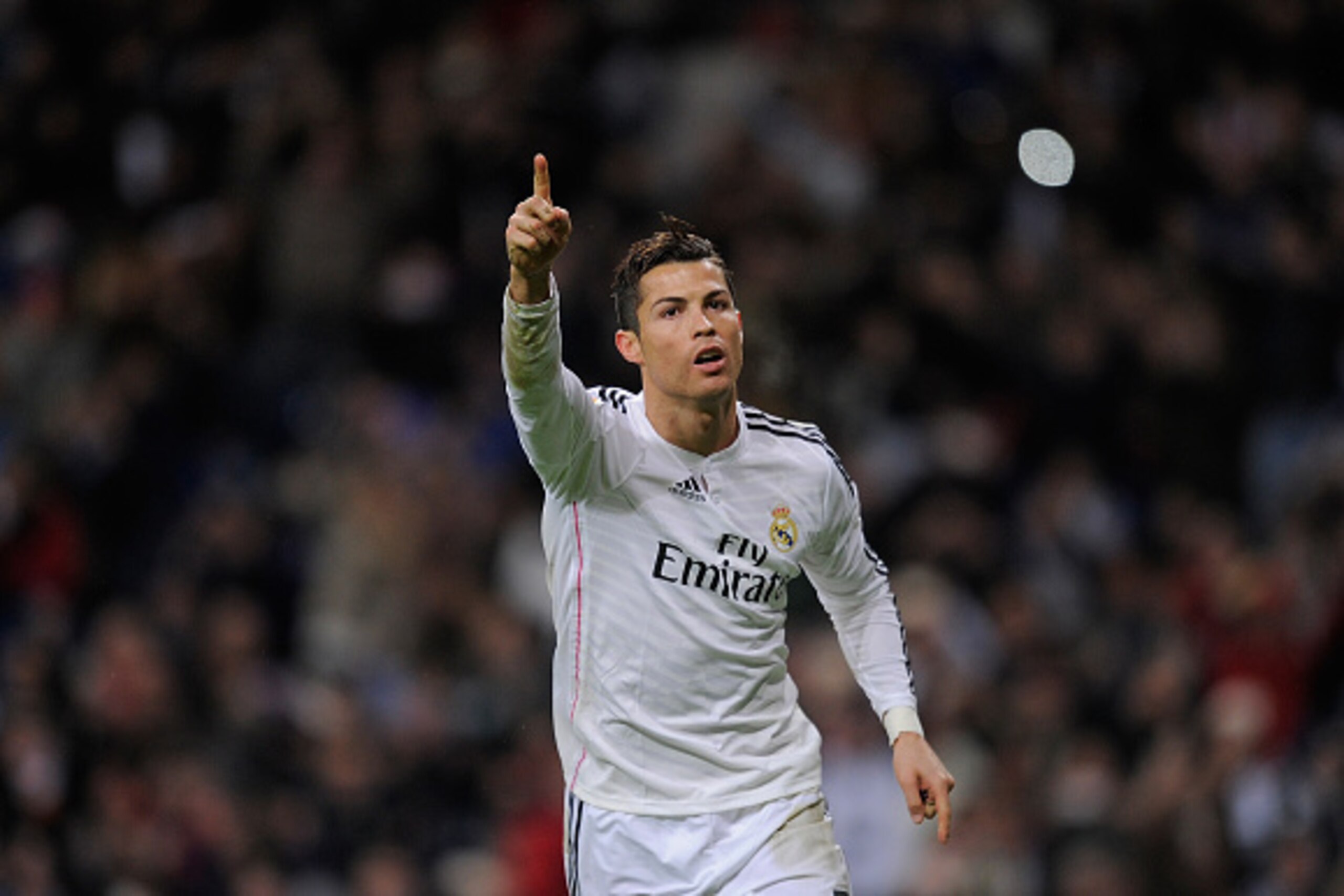 MADRID, SPAIN - DECEMBER 06:  Cristiano Ronaldo of Real Madrid celebrates after scoring Real's opening goal during the La Liga match between Real Madrid CF and Celta Vigo at Estadio Santiago Bernabeu on December 6, 2014 in Madrid, Spain.  (Photo by Denis 