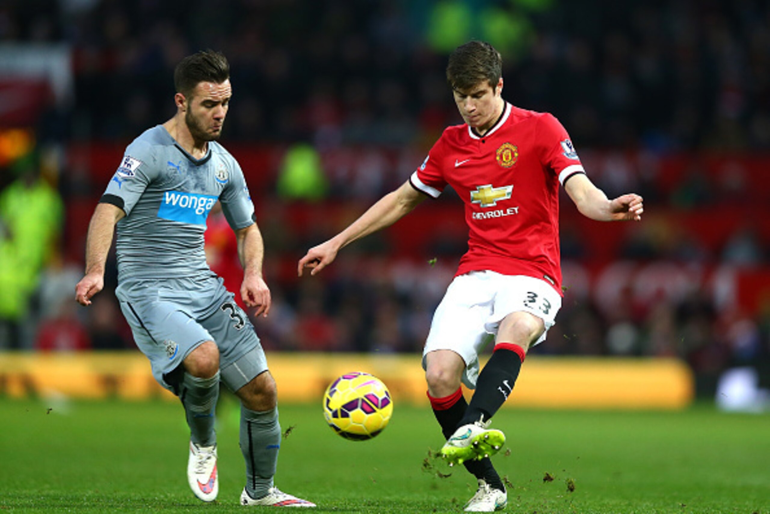 MANCHESTER, ENGLAND - DECEMBER 26:  Patrick McNair of Manchester United competes with Adam Armstrong of Newcastle United during the Barclays Premier League match between Manchester United and Newcastle United at Old Trafford on December 26, 2014 in Manche