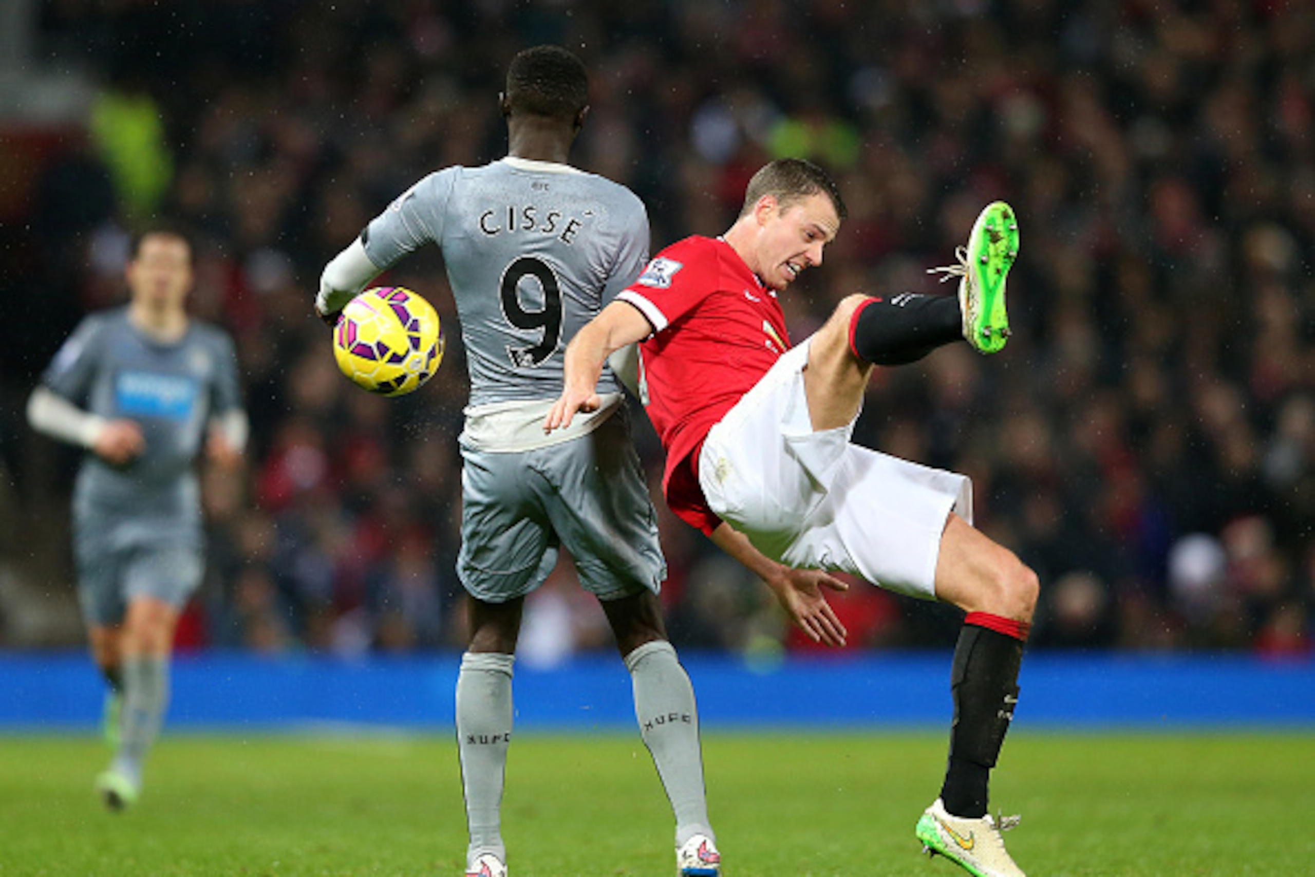 MANCHESTER, ENGLAND - DECEMBER 26:  Jonny Evans of Manchester United tangles with Papiss Cisse of Newcastle United during the Barclays Premier League match between Manchester United and Newcastle United at Old Trafford on December 26, 2014 in Manchester, 