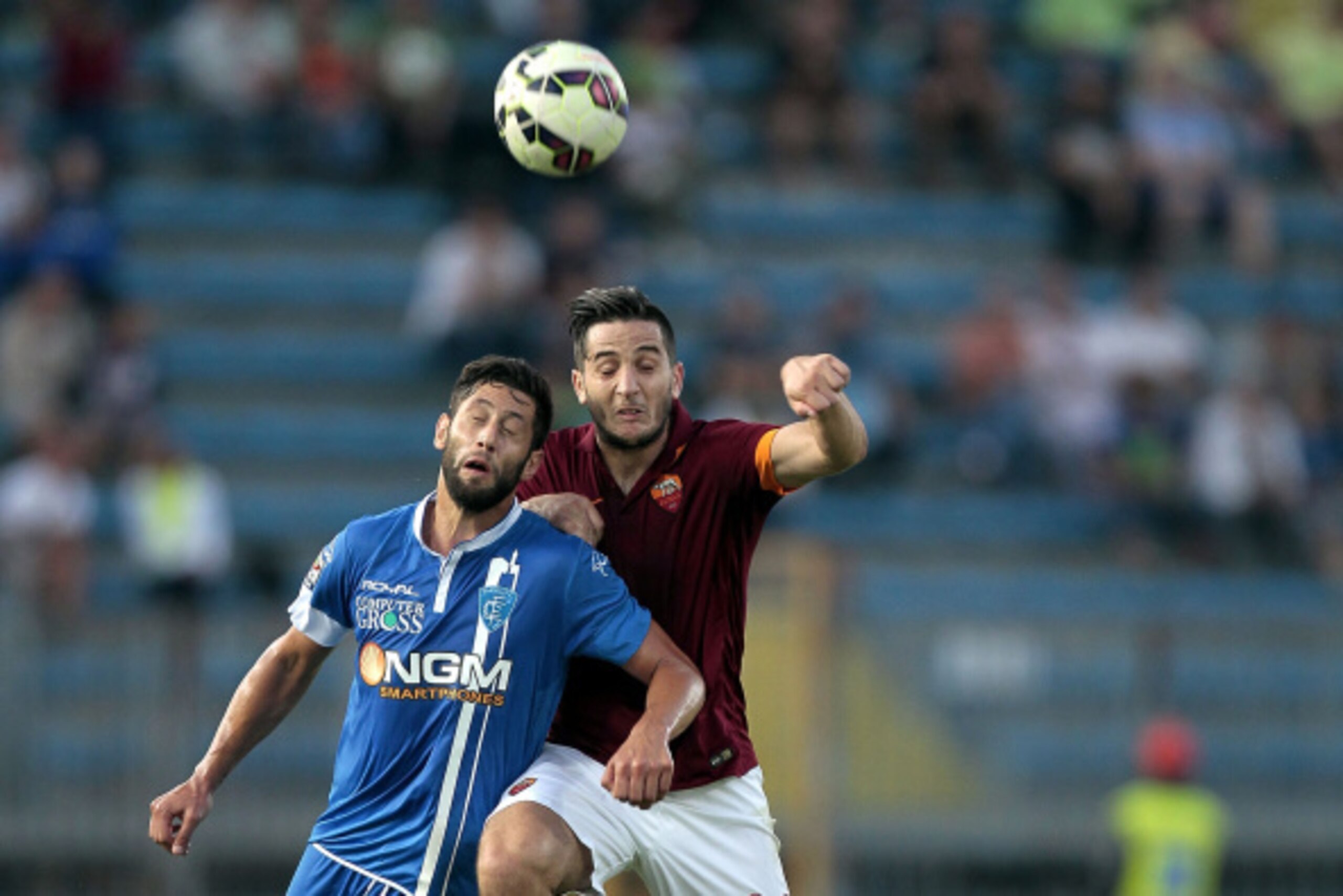 EMPOLI, ITALY - SEPTEMBER 13: Levan Mchedlidze of Empoli Fc battles for the ball with Kostas Manolas of AS Roma during the Serie A match between Empoli FC and AS Roma at Stadio Carlo Castellani on September 13, 2014 in Empoli, Italy.  (Photo by Gabriele M
