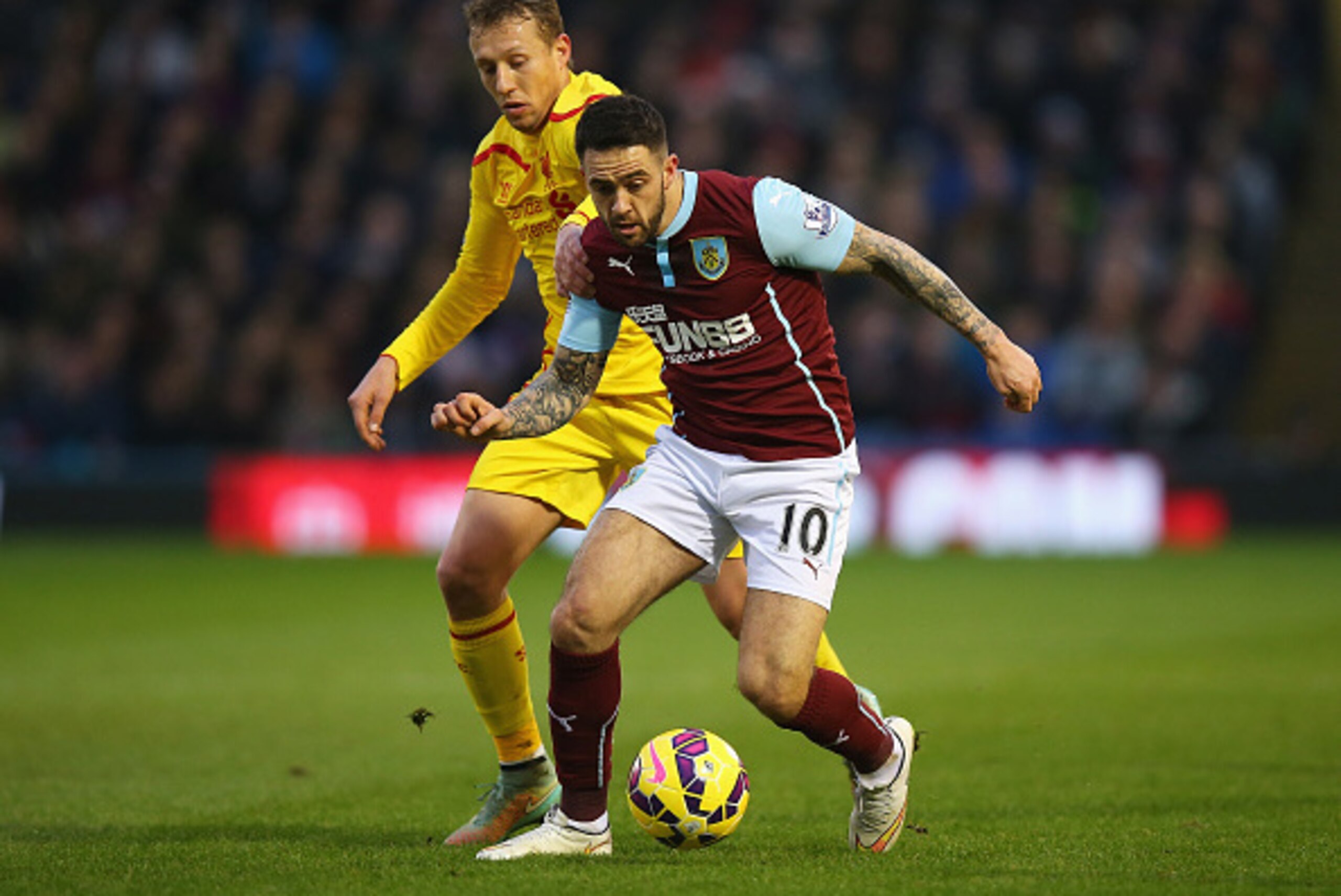 BURNLEY, ENGLAND - DECEMBER 26: Danny Ings of Burnley is closed down by Lucas Leiva of Liverpool during the Barclays Premier League match between Burnley and Liverpool at Turf Moor on December 26, 2014 in Burnley, England.  (Photo by Bryn Lennon/Getty Ima