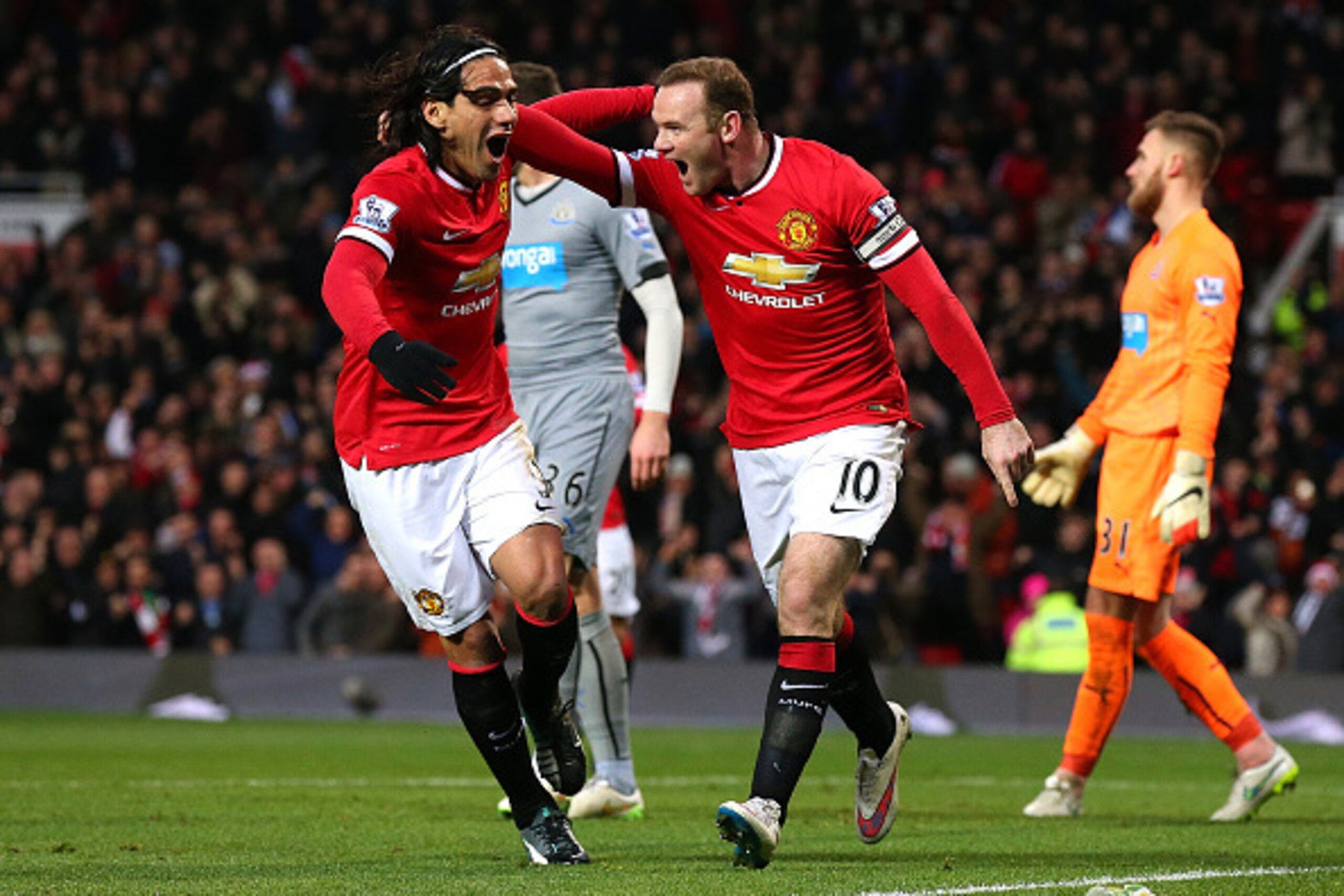 MANCHESTER, ENGLAND - DECEMBER 26:  Wayne Rooney of Manchester United celebrates scoring the first goal with team-mate Radamel Falcao (L) during the Barclays Premier League match between Manchester United and Newcastle United at Old Trafford on December 2