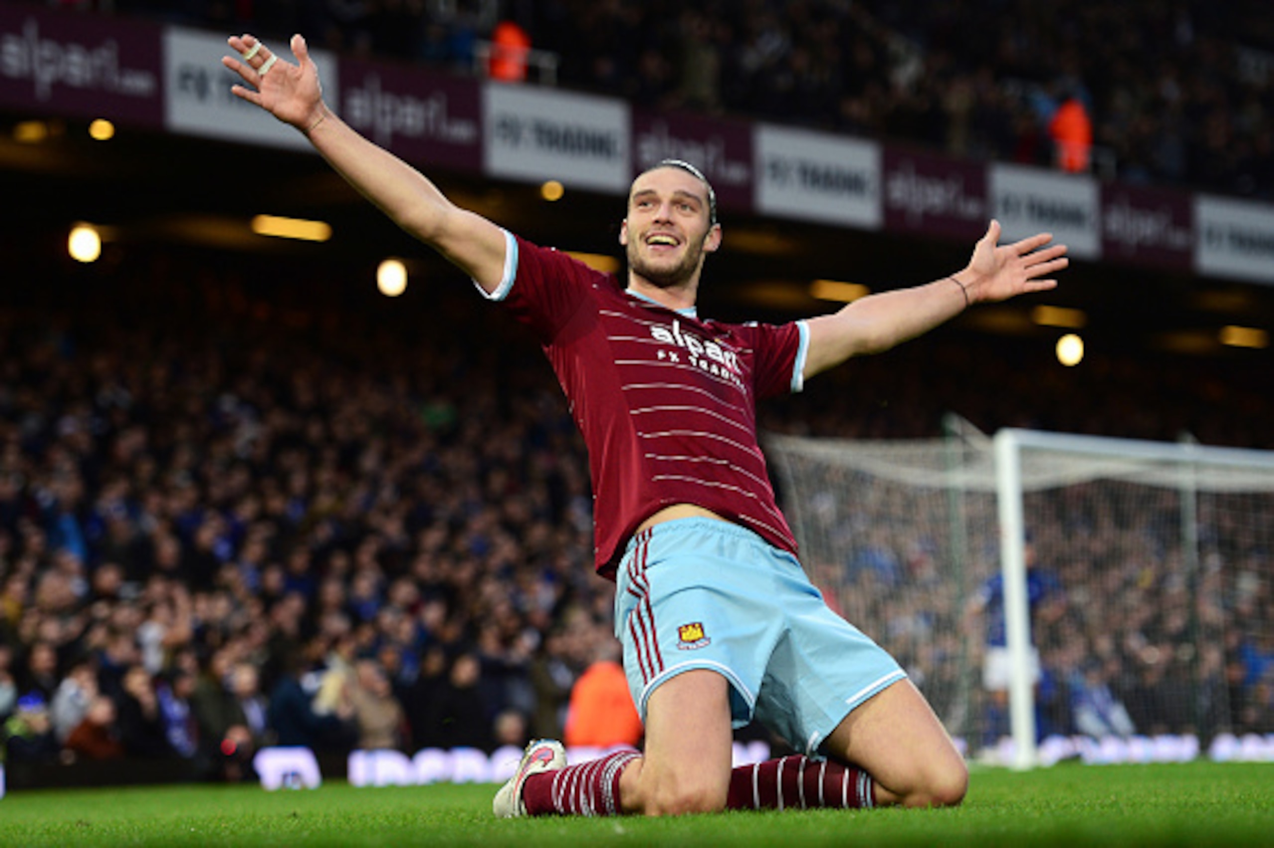 LONDON, ENGLAND - DECEMBER 20: (EDITORS NOTE: This is a re-transmission of image #460712932 with an alternative crop)   Andy Carroll of West Ham celebrates scoring the first goal during the Barclays Premier League match between West Ham United and Leicest