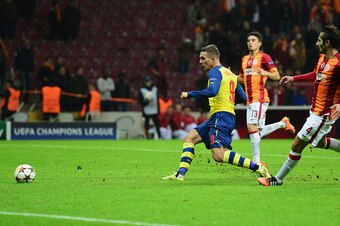 ISTANBUL, TURKEY - DECEMBER 09:  Lukas Podolski of Arsenal scores their fourth goal during the UEFA Champions League Group D match between Galatasaray AS and Arsenal FC at Ali Sami Yen Arena on December 9, 2014 in Istanbul, Turkey.  (Photo by Jamie McDona