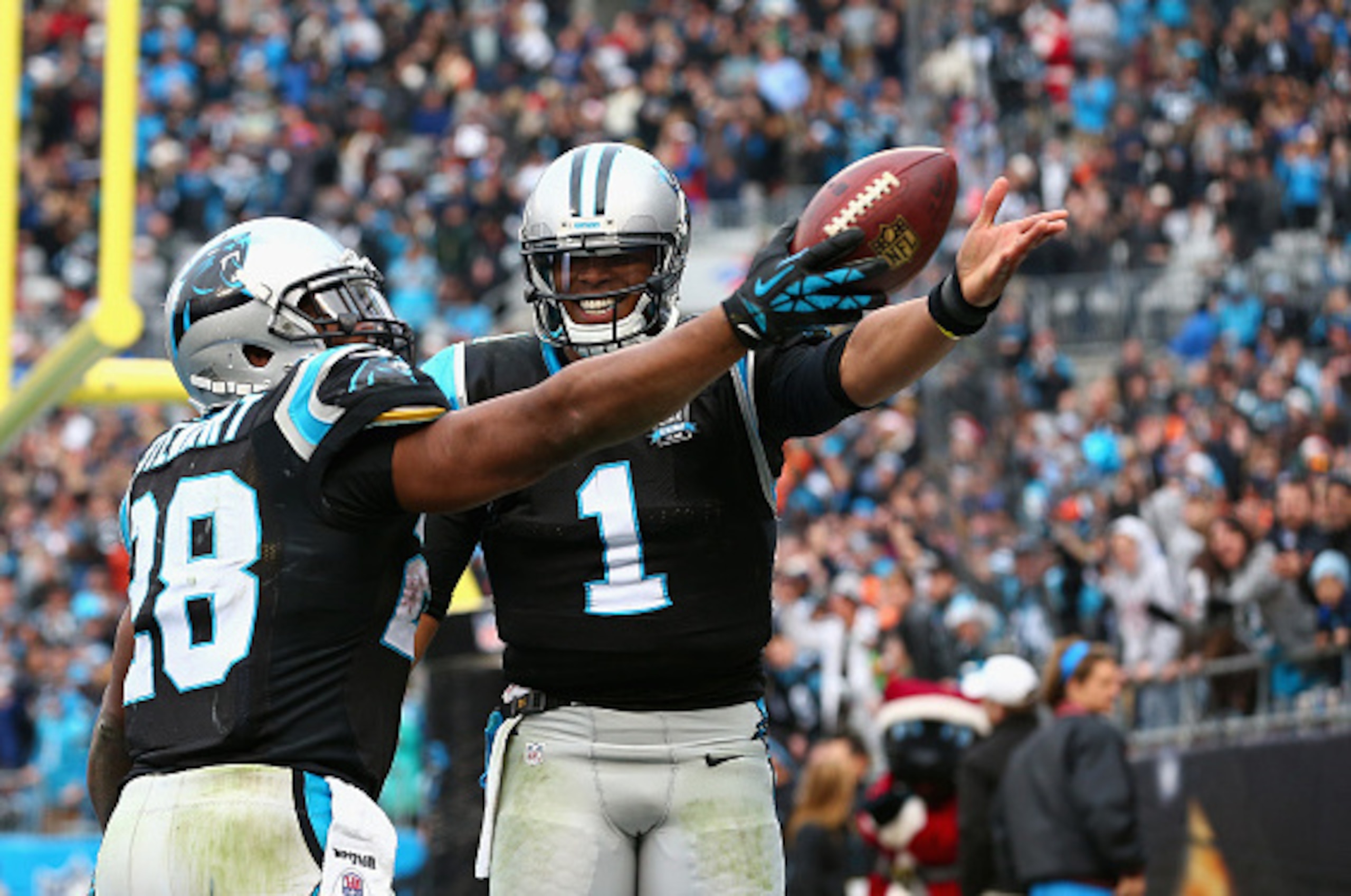 CHARLOTTE, NC - DECEMBER 21:  Cam Newton #1 helps Jonathan Stewart #28 of the Carolina Panthers celebrate his 4th quarter touchdown against the Cleveland Browns during their game at Bank of America Stadium on December 21, 2014 in Charlotte, North Carolina
