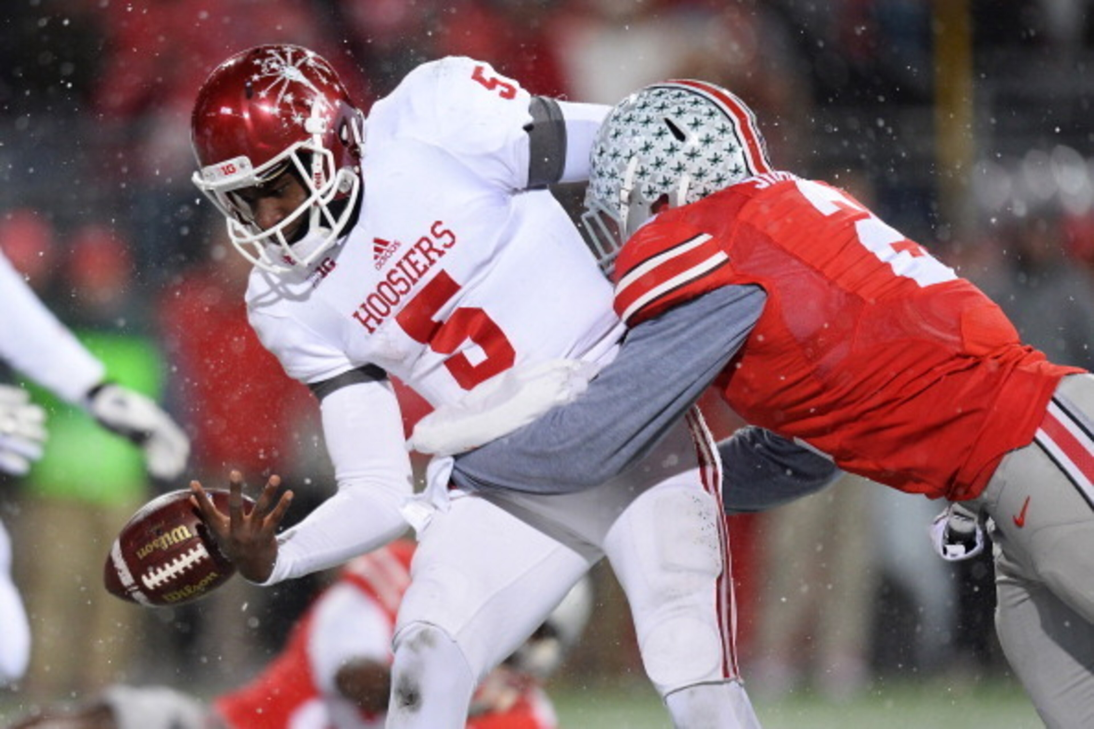 COLUMBUS, OH - NOVEMBER 23:  Quarterback Tre Roberson #5 of the Indiana Hoosiers fumbles the ball near the goal line as he is hit by Ryan Shazier #2 of the Ohio State Buckeyes in the third period at Ohio Stadium on November 23, 2013 in Columbus, Ohio. Rob