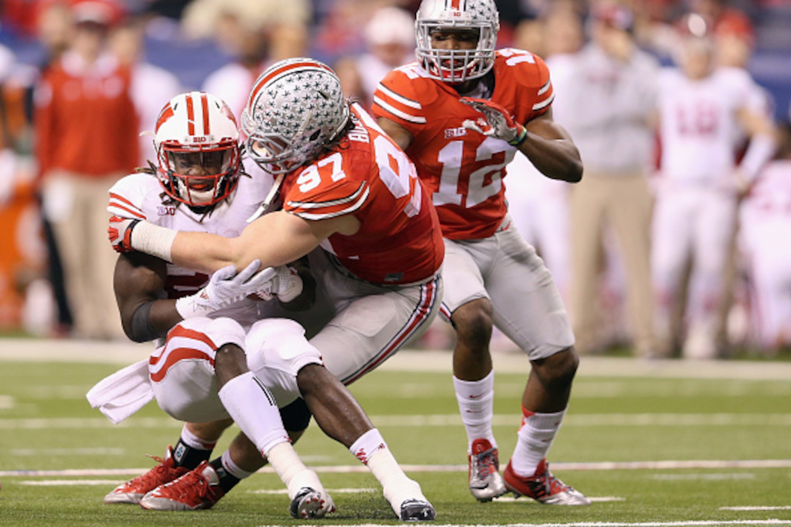 INDIANAPOLIS, IN - DECEMBER 06: Joey Bosa #97 of the Ohio State Buckeyes tackles Melvin Gordon #25 of the Wisconsin Badgers in the first half of the Big Ten Championship at Lucas Oil Stadium on December 6, 2014 in Indianapolis, Indiana. (Photo by Andy L INDIANAPOLIS, IN - DECEMBER 06: Joey Bosa #97 of the Ohio State Buckeyes tackles Melvin Gordon #25 of the Wisconsin Badgers in the first half of the Big Ten Championship at Lucas Oil Stadium on December 6, 2014 in Indianapolis, Indiana. (Photo by Andy L