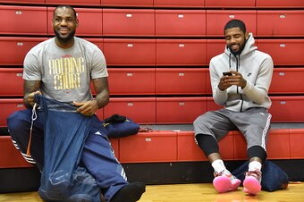 NEW YORK, NY- DECEMBER 7:  LeBron James #23 and Kyrie Irving #2 of the Cleveland Cavaliers smile and talk at practice on December 7, 2014 at Baruch College in New York, New York. NOTE TO USER: User expressly acknowledges and agrees that, by downloading an