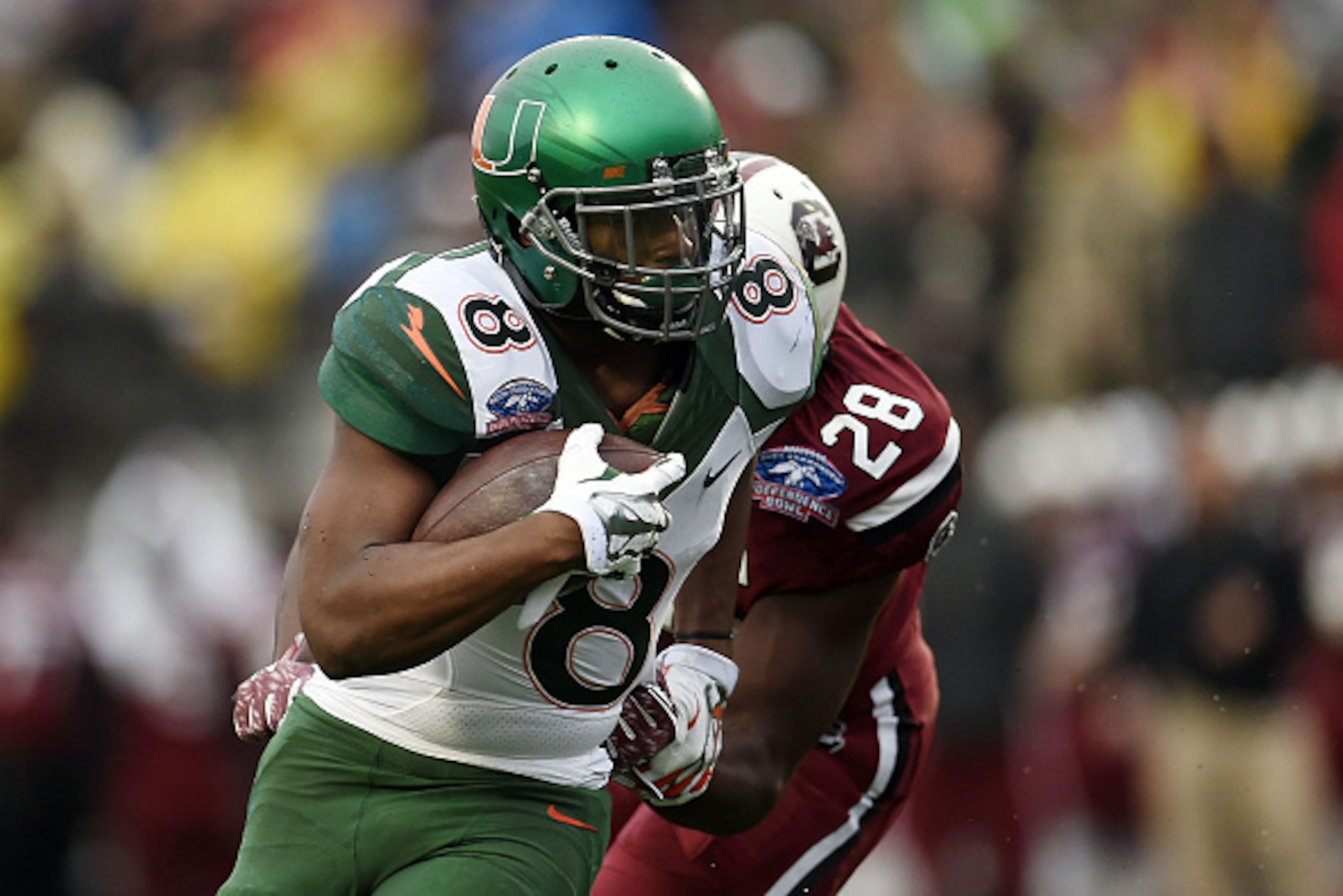 SHREVEPORT, LA - DECEMBER 27: Duke Johnson #8 of the Miami Hurricanes avoids a tackle by Jonathan Walton #28 of the South Carolina Gamecocks during the first quarter of the Duck Commander Independence Bowl at Independence Stadium on December 27, 2014 in SHREVEPORT, LA - DECEMBER 27: Duke Johnson #8 of the Miami Hurricanes avoids a tackle by Jonathan Walton #28 of the South Carolina Gamecocks during the first quarter of the Duck Commander Independence Bowl at Independence Stadium on December 27, 2014 in