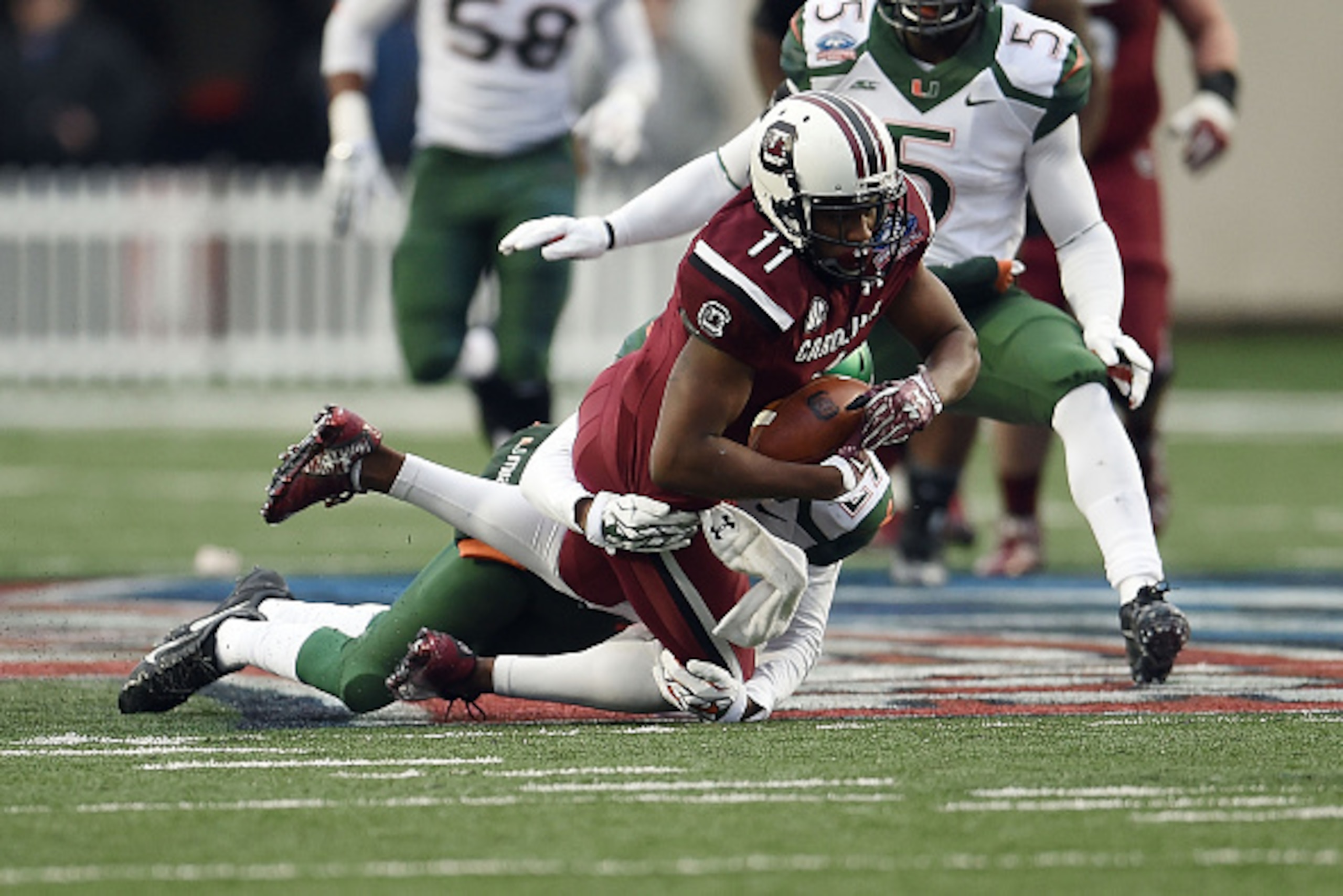 SHREVEPORT, LA - DECEMBER 27: Pharoh Cooper #11 of the South Carolina Gamecocks is brought down by Corn Elder #29 of the Miami Hurricanes during the second quarter of the Duck Commander Independence Bowl at Independence Stadium on December 27, 2014 in Sh SHREVEPORT, LA - DECEMBER 27: Pharoh Cooper #11 of the South Carolina Gamecocks is brought down by Corn Elder #29 of the Miami Hurricanes during the second quarter of the Duck Commander Independence Bowl at Independence Stadium on December 27, 2014 in Sh