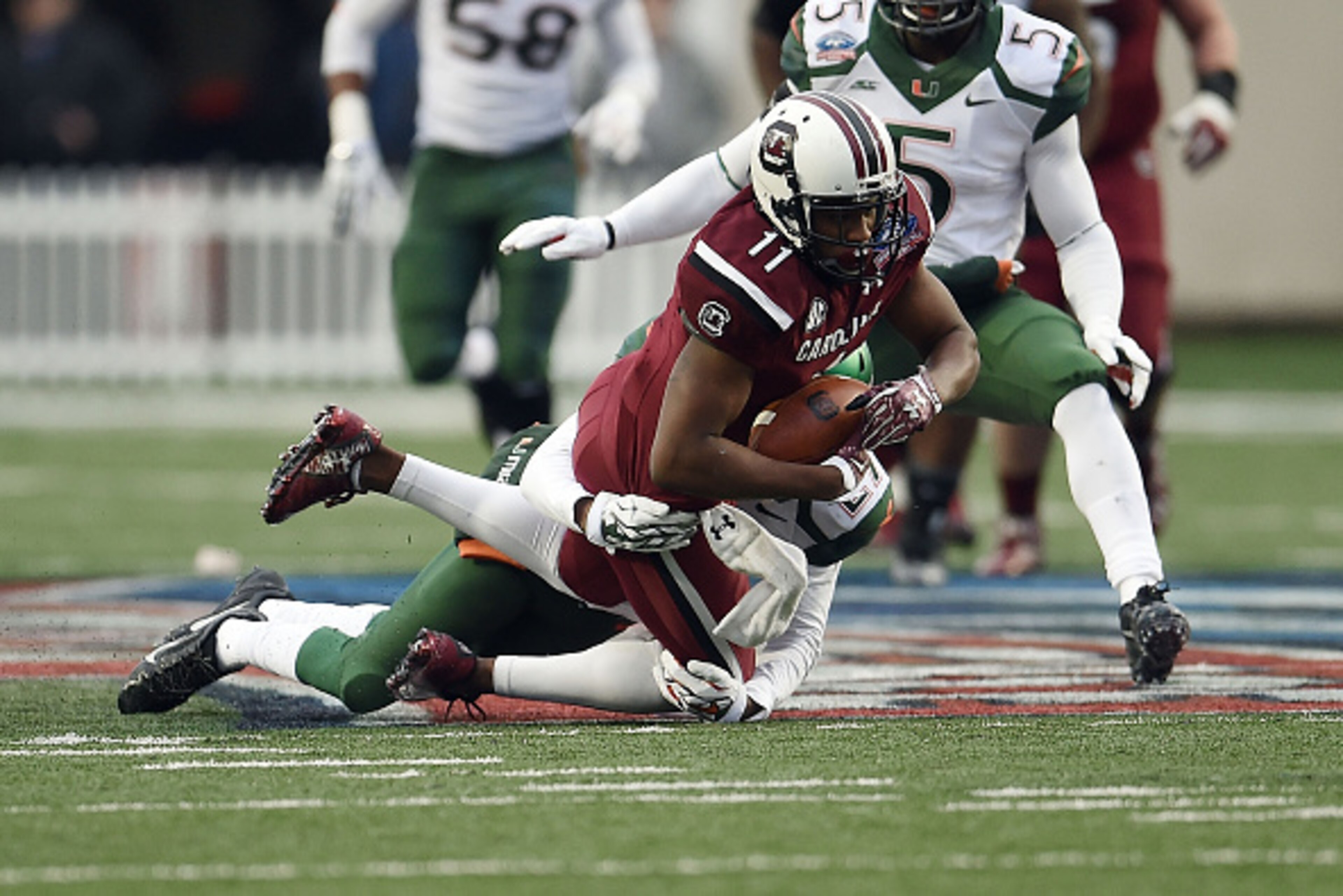 SHREVEPORT, LA - DECEMBER 27: Pharoh Cooper #11 of the South Carolina Gamecocks is brought down by Corn Elder #29 of the Miami Hurricanes during the second quarter of the Duck Commander Independence Bowl at Independence Stadium on December 27, 2014 in Sh SHREVEPORT, LA - DECEMBER 27: Pharoh Cooper #11 of the South Carolina Gamecocks is brought down by Corn Elder #29 of the Miami Hurricanes during the second quarter of the Duck Commander Independence Bowl at Independence Stadium on December 27, 2014 in Sh