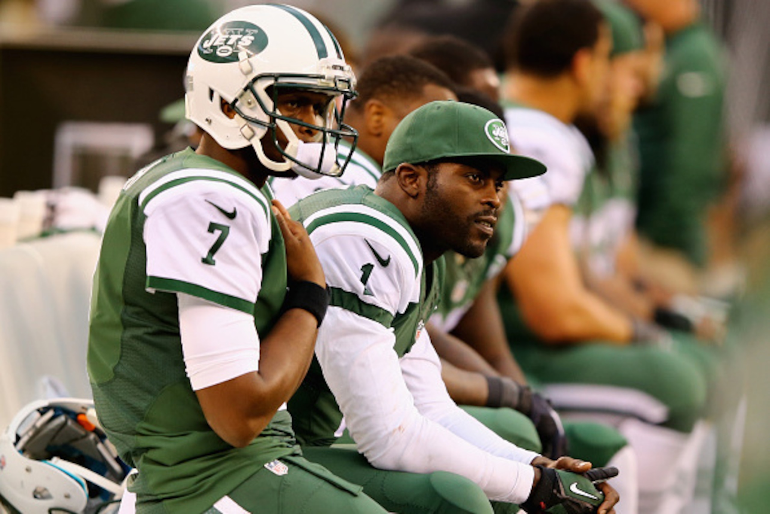 EAST RUTHERFORD, NJ - OCTOBER 26:  Quarterbacks Geno Smith #7 of the New York Jets and Michael Vick #1 look on from the bench in the fourth quarter against the Buffalo Bills at MetLife Stadium on October 26, 2014 in East Rutherford, New Jersey. The Bills 