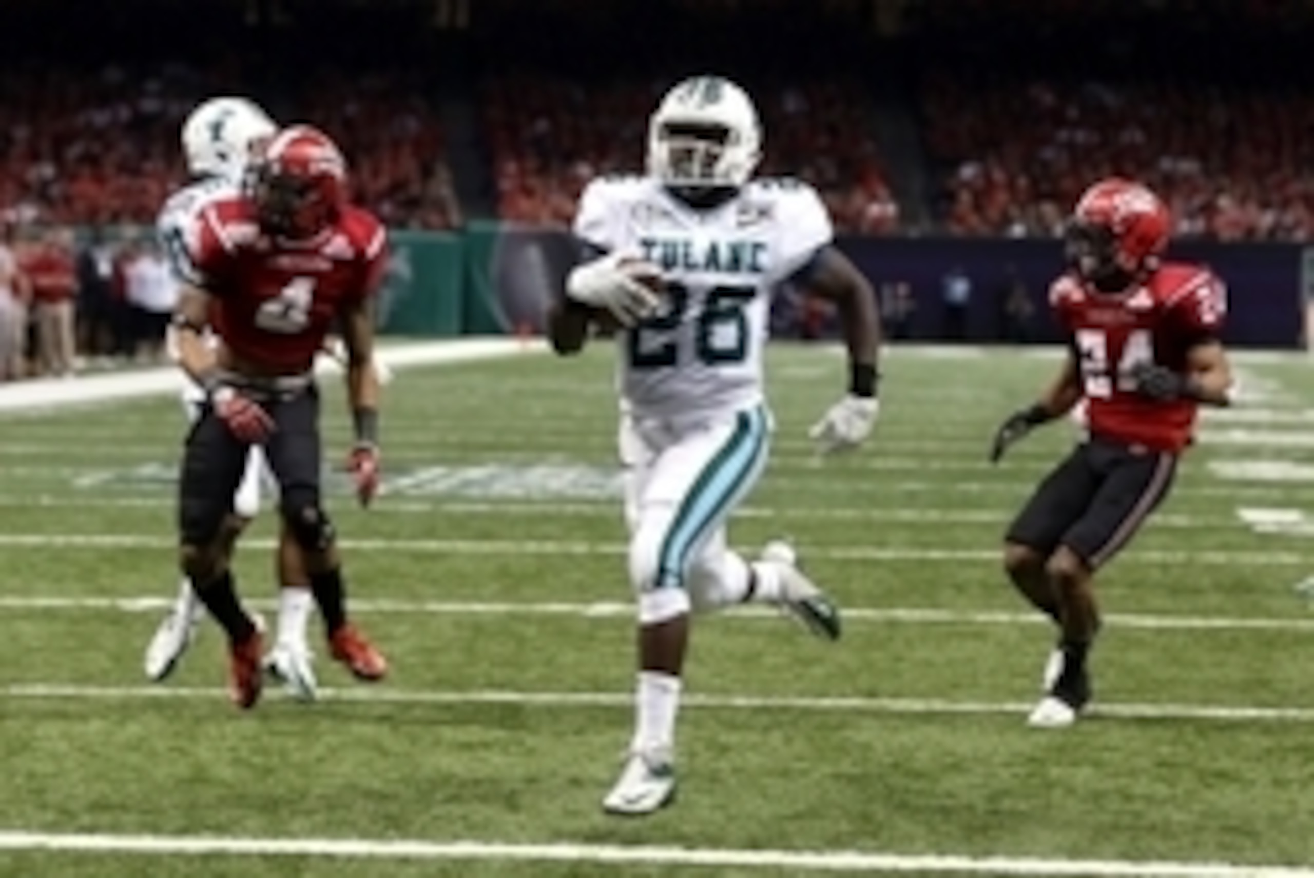 Dec 21, 2013; New Orleans, LA, USA; Tulane Green Wave running back Orleans Darkwa (26) scores a touchdown on a 22-yard run against the Louisiana-Lafayette Ragin Cajuns during the second half of the R&L Carriers New Orleans Bowl at the Mercedes-Benz Superd