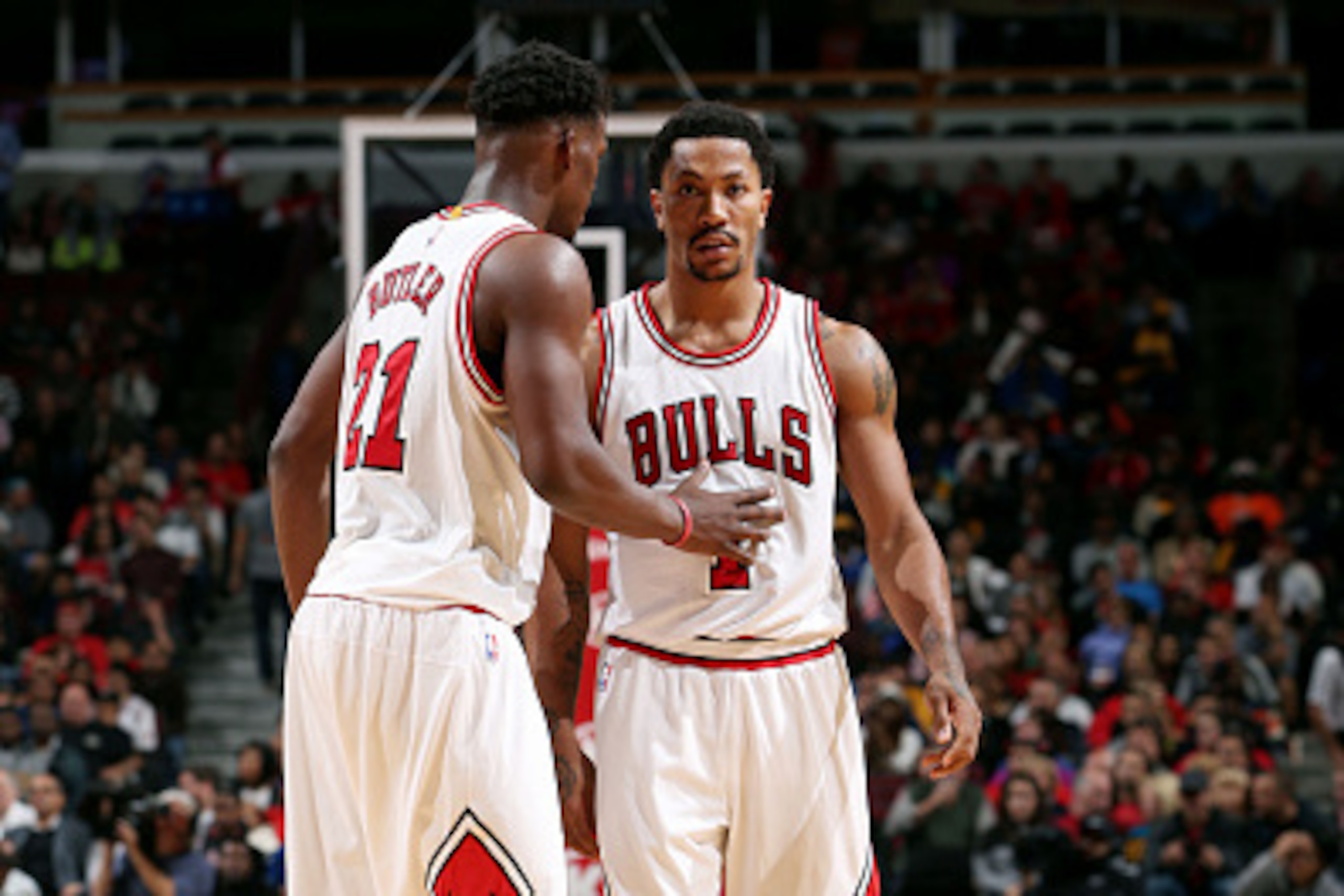 CHICAGO, IL - OCTOBER 13: Jimmy Butler #21 and Derrick Rose #1 of the Chicago Bulls speak during a game against the Denver Nuggets on October 13, 2014 at United Center, Chicago, Illinois. NOTE TO USER: User expressly acknowledges and agrees that, by downl
