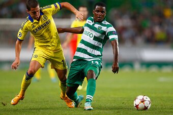 LISBON, PORTUGAL - SEPTEMBER 30:  William Carvalho of Sporting Lisbon battles with Eden Hazard of Chelsea during the UEFA Champions League Group G match between Sporting Clube de Portugal and Chelsea FC at Estadio Jose Alvalade on September 30, 2014 in Li