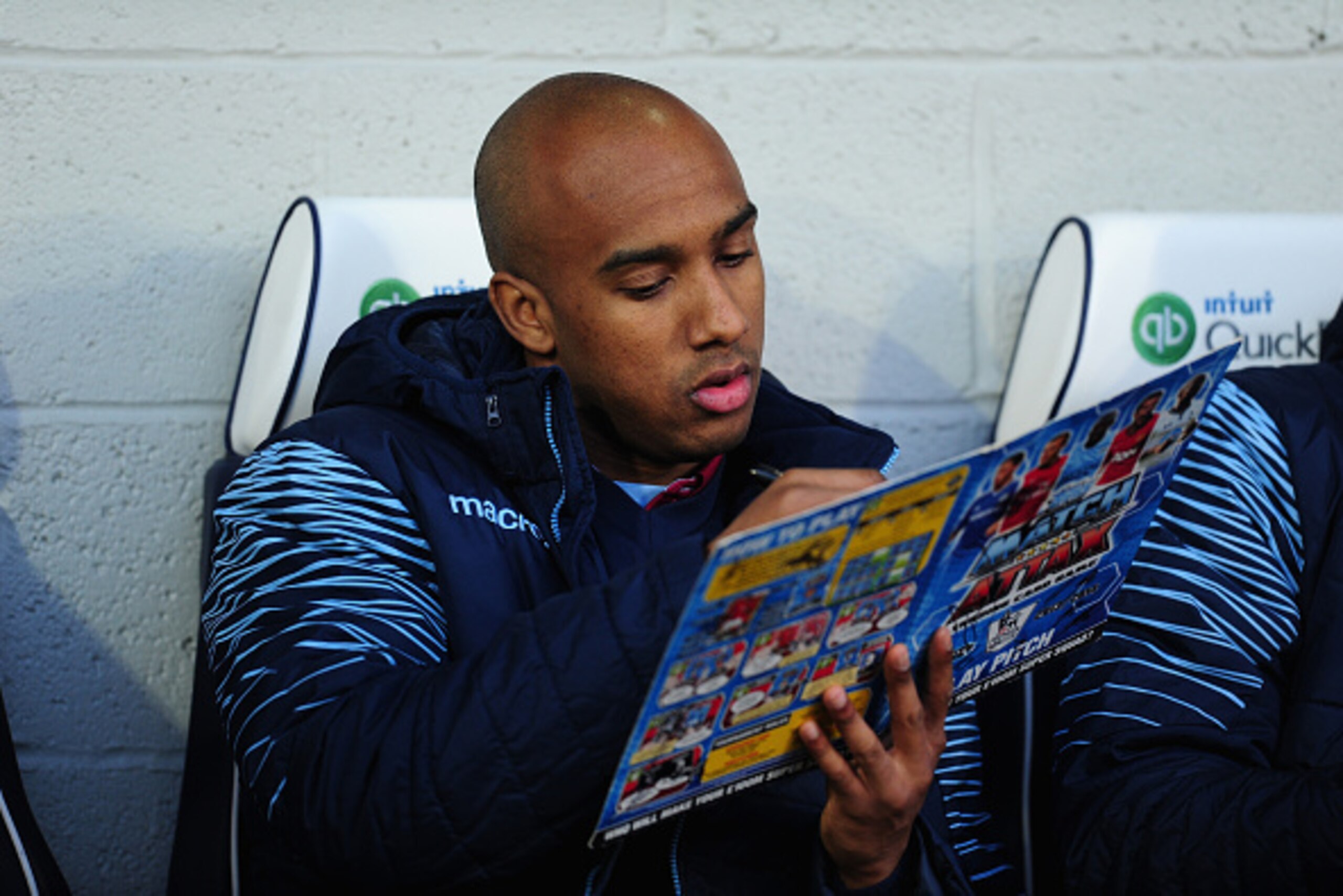 WEST BROMWICH, ENGLAND - DECEMBER 13: Fabian Delph of Villa signs a fans Topps Match Attax book before the Barclays Premier League match between West Bromwich Albion and Aston Villa at The Hawthorns on December 13, 2014 in West Bromwich, England. (Photo WEST BROMWICH, ENGLAND - DECEMBER 13: Fabian Delph of Villa signs a fans Topps Match Attax book before the Barclays Premier League match between West Bromwich Albion and Aston Villa at The Hawthorns on December 13, 2014 in West Bromwich, England. (Photo