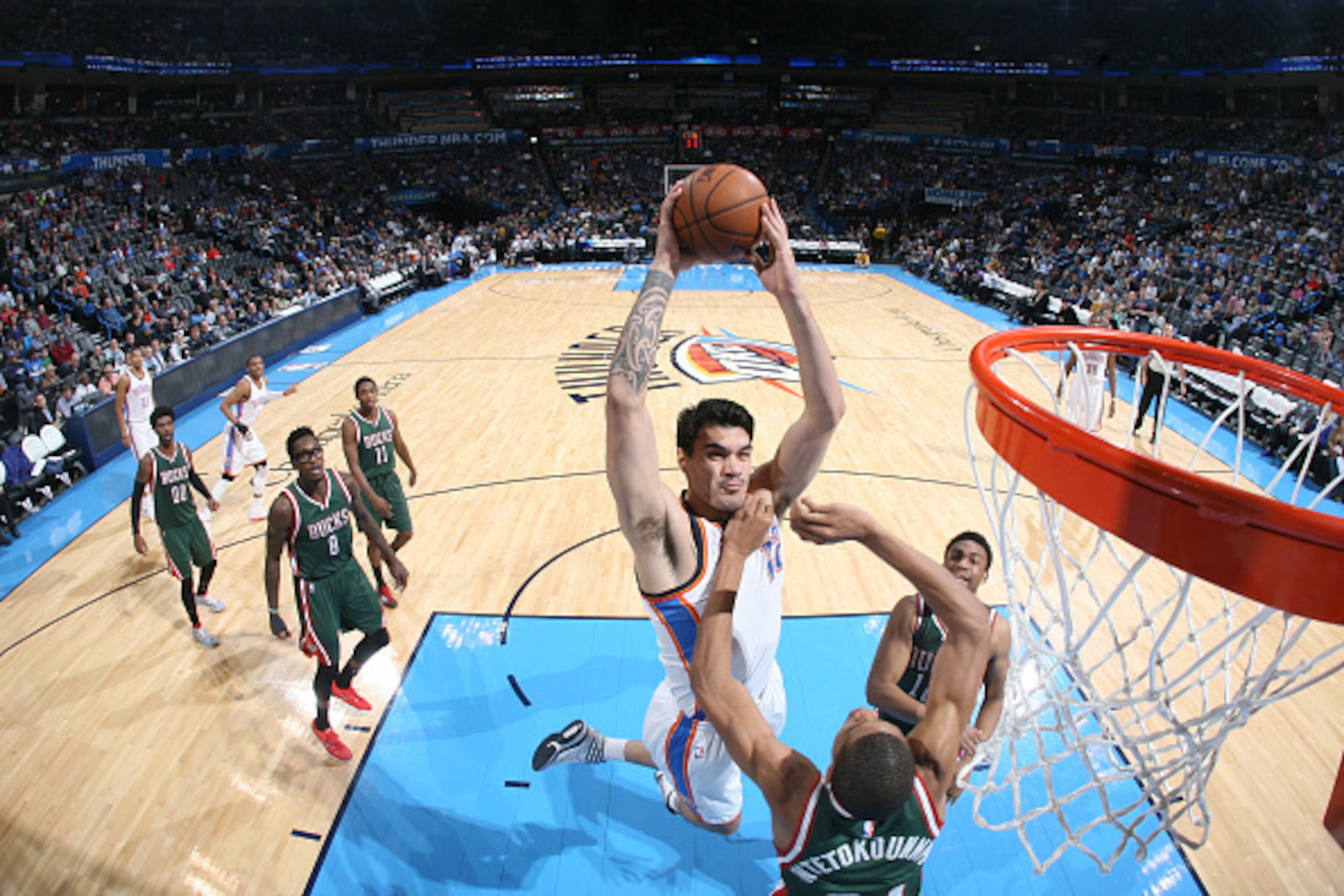 OKLAHOMA CITY, OK- DECEMBER 9: Steven Adams #12 of the Oklahoma City Thunder dunks against the Milwaukee Bucks on December 9, 2014 at Chesapeake Energy Arena in Oklahoma City, OK. NOTE TO USER: User expressly acknowledges and agrees that, by downloading a