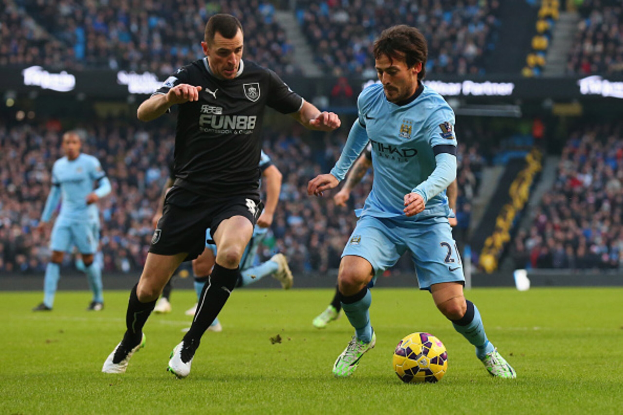 MANCHESTER, ENGLAND - DECEMBER 28: Dean Marney of Burnley closes down David Silva of Manchester City  during the Barclays Premier League match between Manchester City and Burnley at Etihad Stadium on December 28, 2014 in Manchester, England.  (Photo by Al