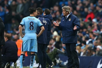 MANCHESTER, ENGLAND - DECEMBER 28:  Manuel Pellegrini the manager of Manchester City talks with Samir Nasri during the Barclays Premier League match between Manchester City and Burnley at Etihad Stadium on December 28, 2014 in Manchester, England.  (Photo