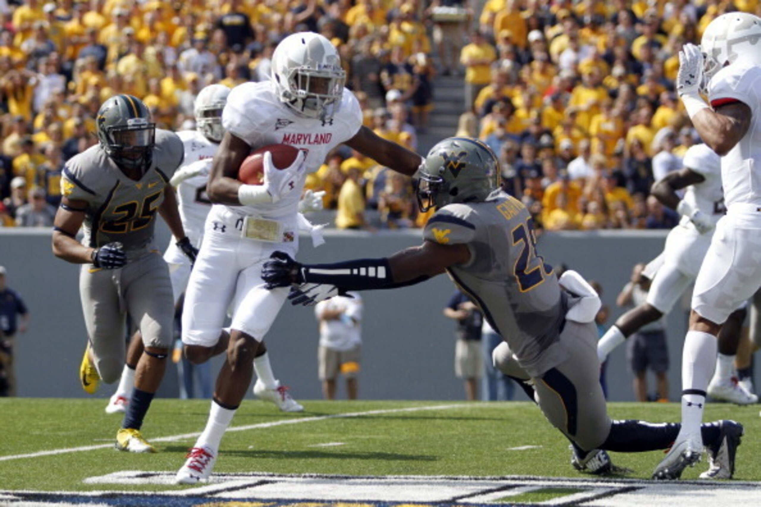 MORGANTOWN, WV - SEPTEMBER 22: Stefon Diggs #1 of the Maryland Terrapins carries the ball against Terence Garvin #28 of the West Virginia Mountaineers during the game on September 22, 2012 at Mountaineer Field in Morgantown, West Virginia. (Photo by Jus MORGANTOWN, WV - SEPTEMBER 22: Stefon Diggs #1 of the Maryland Terrapins carries the ball against Terence Garvin #28 of the West Virginia Mountaineers during the game on September 22, 2012 at Mountaineer Field in Morgantown, West Virginia. (Photo by Jus