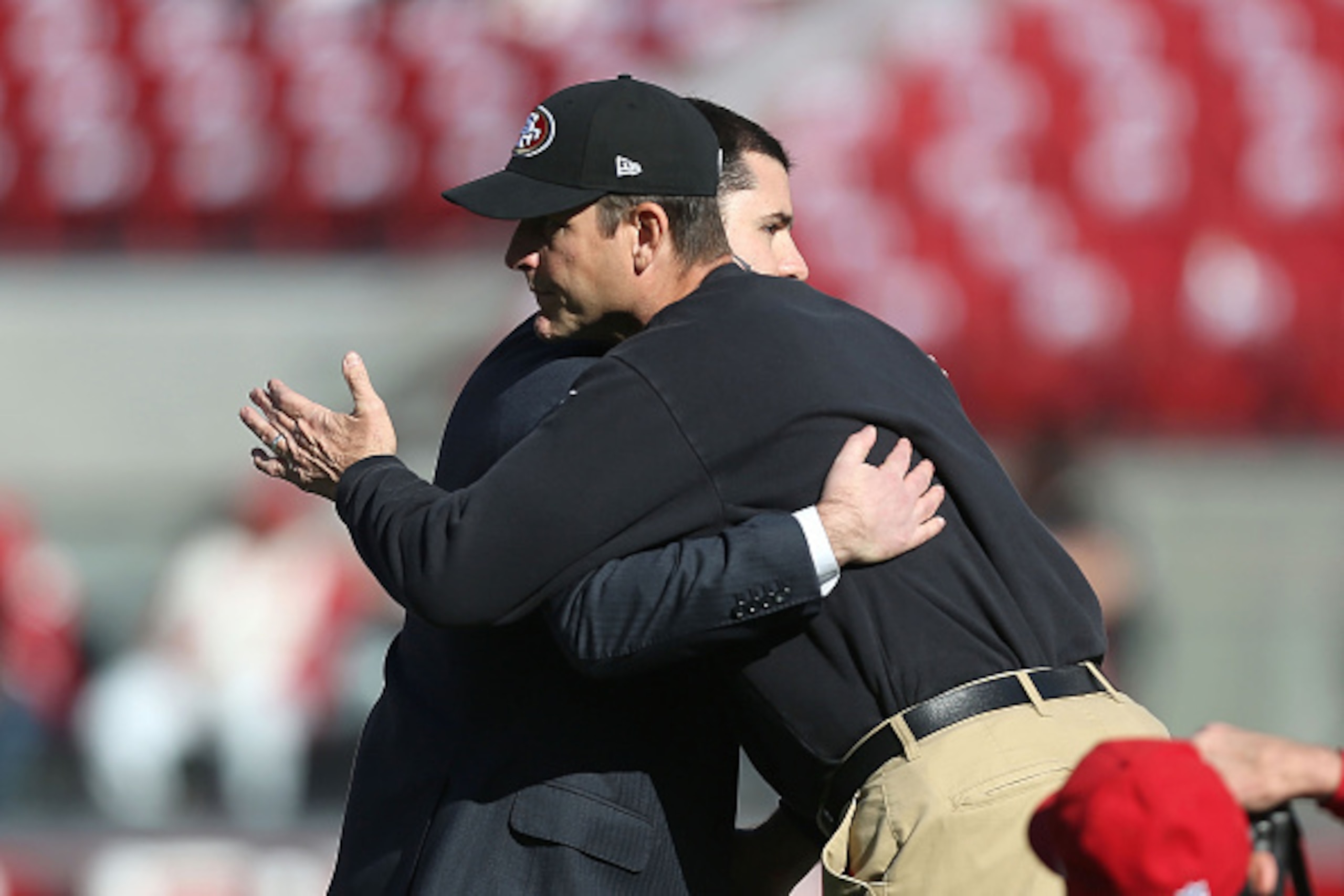 SANTA CLARA, CA - DECEMBER 28: head coach Jim Harbaugh of the San Francisco 49ers and CEO Jed York talk at midfield during warm ups against the Arizona Cardinals at Levi's Stadium on December 28, 2014 in Santa Clara, California.  (Photo by Don Feria/Getty