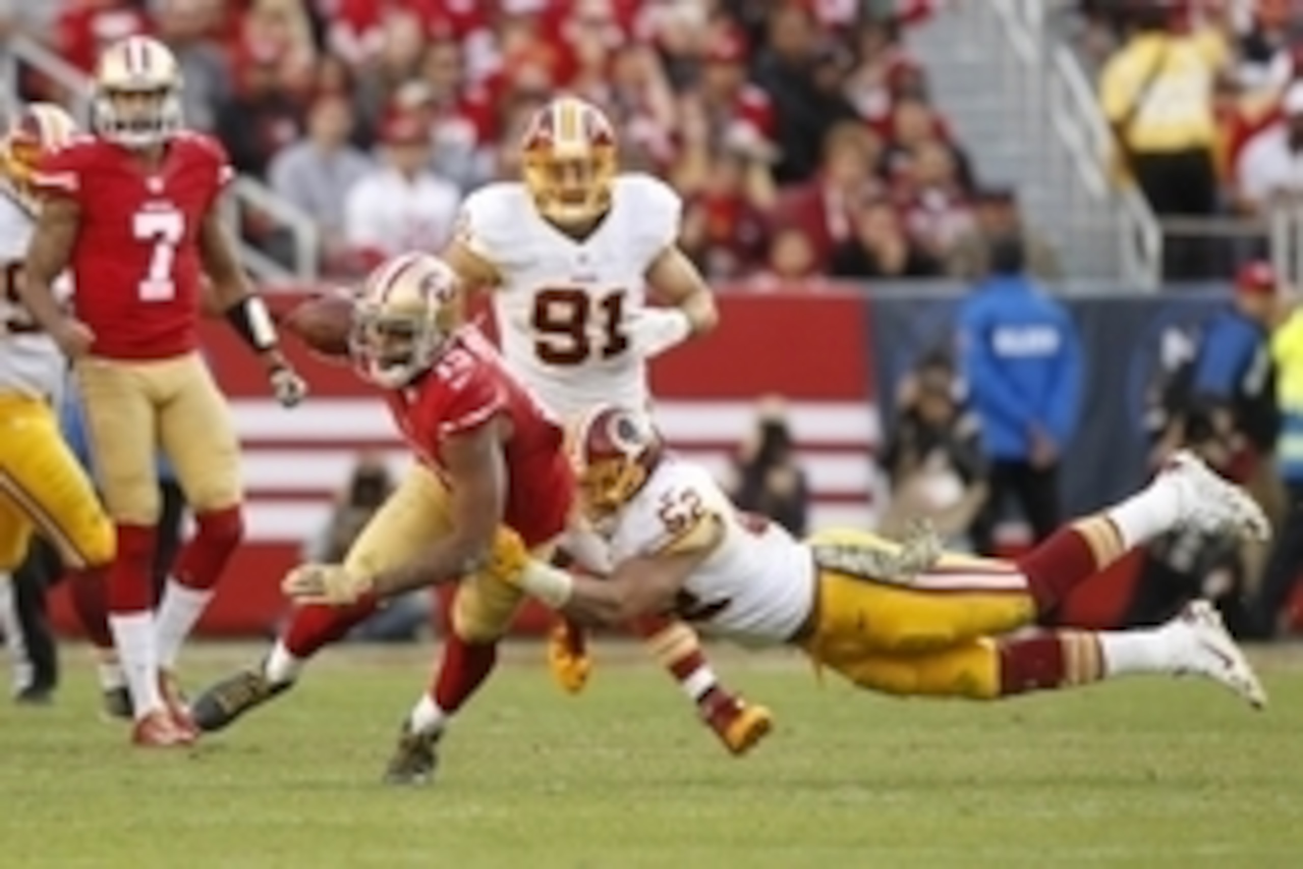 Nov 23, 2014; Santa Clara, CA, USA; San Francisco 49ers wide receiver Michael Crabtree (15) is tackled by Washington Redskins inside linebacker Keenan Robinson (52) after making a catch in the third quarter at Levi's Stadium. The 49ers defeated the Redski