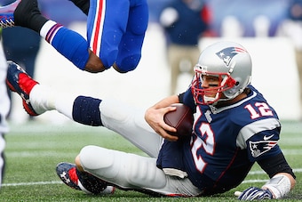FOXBORO, MA - DECEMBER 28:  Tom Brady #12 of the New England Patriots slides with the ball during the second quarter against the Buffalo Bills at Gillette Stadium on December 28, 2014 in Foxboro, Massachusetts.  (Photo by Jared Wickerham/Getty Images)