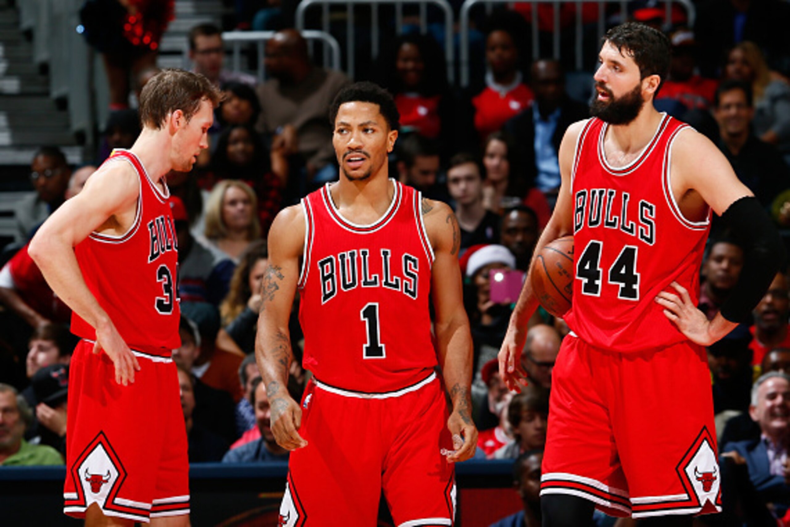 ATLANTA, GA - DECEMBER 15:  Mike Dunleavy #34, Derrick Rose #1 and Nikola Mirotic #44 of the Chicago Bulls react after a foul during the game against the Atlanta Hawks at Philips Arena on December 15, 2014 in Atlanta, Georgia.  NOTE TO USER: User expressl