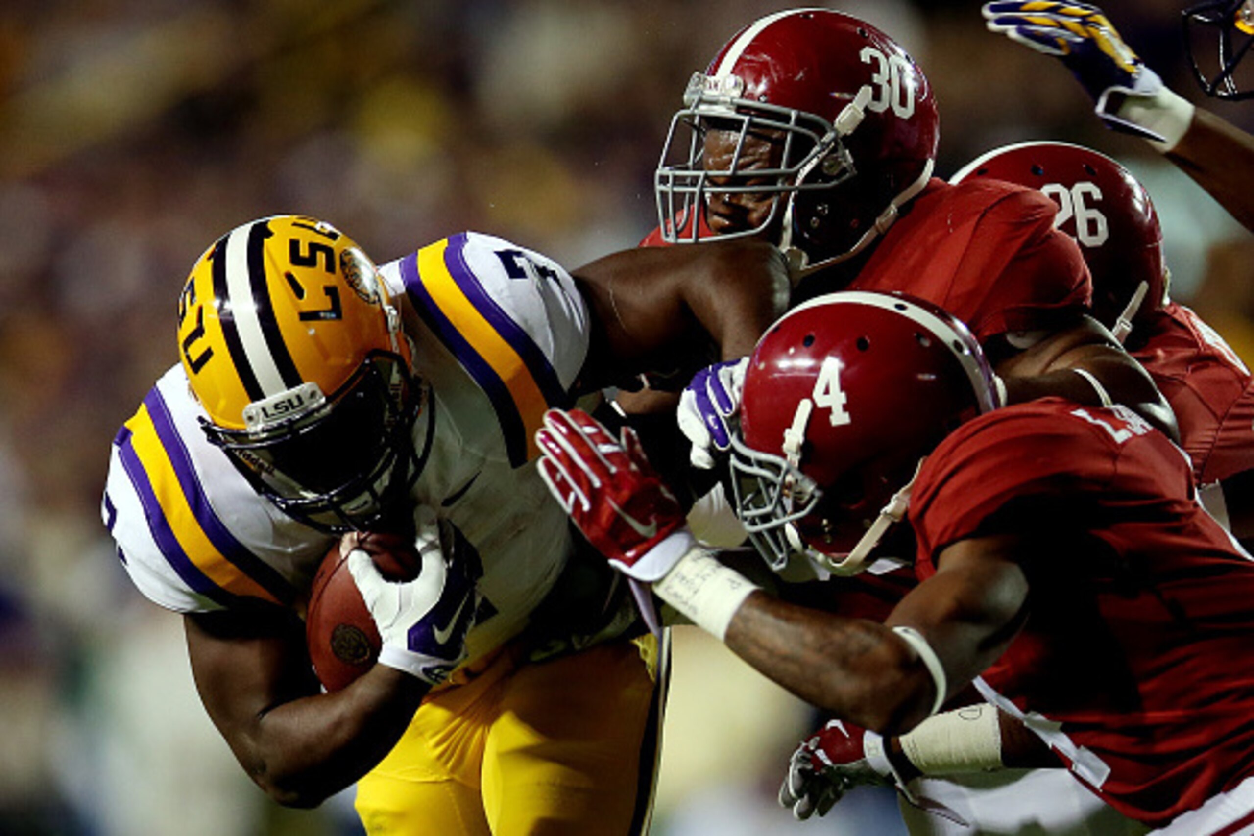 BATON ROUGE, LA - NOVEMBER 08: Leonard Fournette #7 of the LSU Tigers is tackled by Denzel Devall #30 and Eddie Jackson #4 of the Alabama Crimson Tide during a game at Tiger Stadium on November 8, 2014 in Baton Rouge, Louisiana.  (Photo by Chris Graythen/