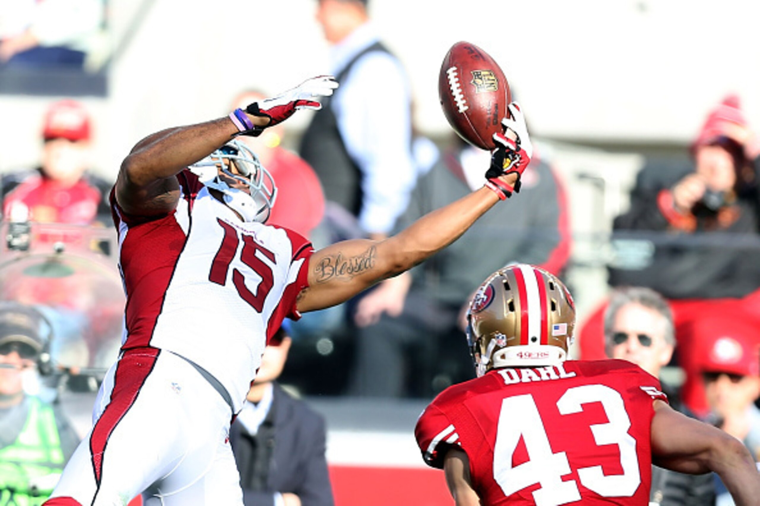 SANTA CLARA, CA - DECEMBER 28: Michael Floyd #15 of the Arizona Cardinals completes a pass in the first half in front of Craig Dahl #43 of the San Francisco 49ers at Levi's Stadium on December 28, 2014 in Santa Clara, California.  (Photo by Don Feria/Gett