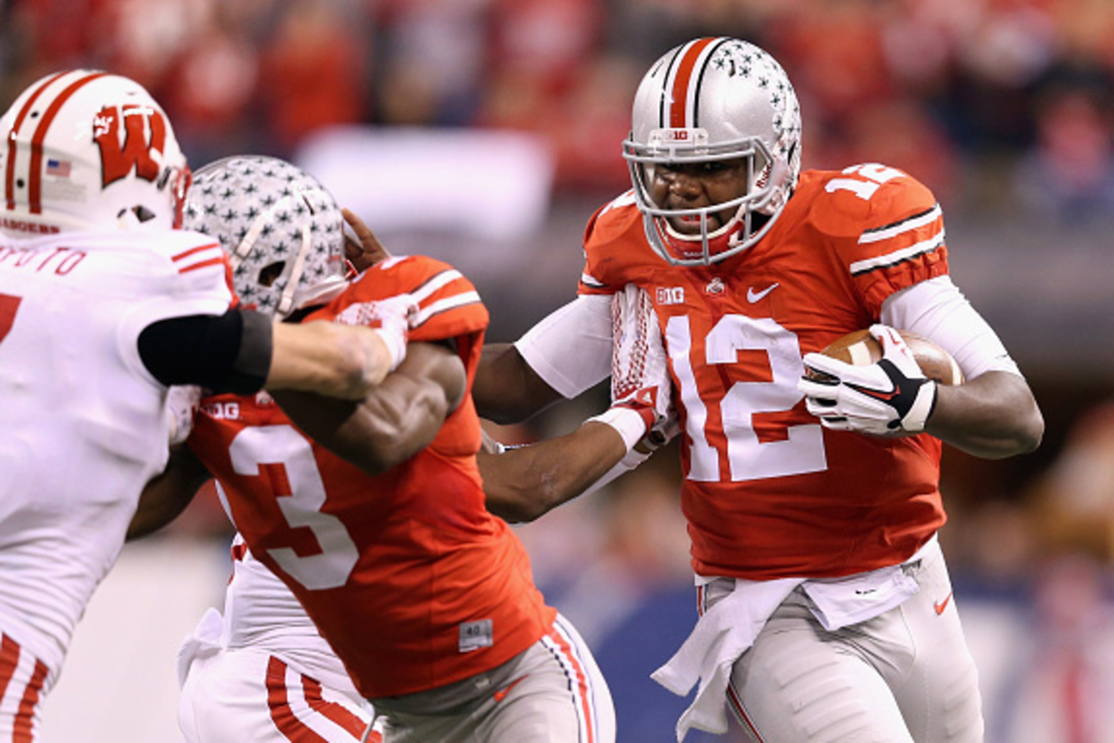 INDIANAPOLIS, IN - DECEMBER 06: Quarterback Cardale Jones #12 of the Ohio State Buckeyes runs with the ball during the third quarter against the Wisconsin Badgers in the Big Ten Championship at Lucas Oil Stadium on December 6, 2014 in Indianapolis, India INDIANAPOLIS, IN - DECEMBER 06: Quarterback Cardale Jones #12 of the Ohio State Buckeyes runs with the ball during the third quarter against the Wisconsin Badgers in the Big Ten Championship at Lucas Oil Stadium on December 6, 2014 in Indianapolis, India