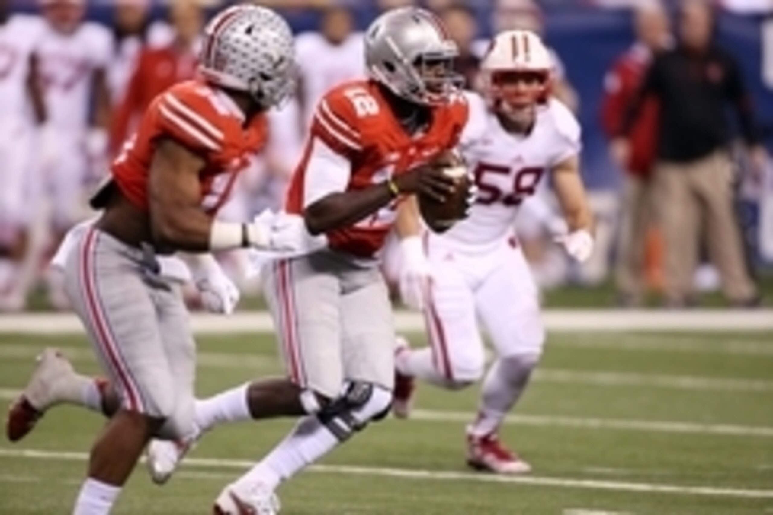 Dec 6, 2014; Indianapolis, IN, USA; Ohio State Buckeyes quarterback Cardale Jones (12) runs with the ball against the Wisconsin Badgers during the Big Ten football championship game at Lucas Oil Stadium. Mandatory Credit: Brian Spurlock-USA TODAY Sports