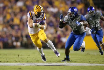Oct 18, 2014; Baton Rouge, LA, USA; LSU Tigers tight end Travis Dickson (41) carries the ball beside Kentucky Wildcats defensive end Alvin Dupree (2) at Tiger Stadium. Mandatory Credit: Crystal LoGiudice-USA TODAY Sports