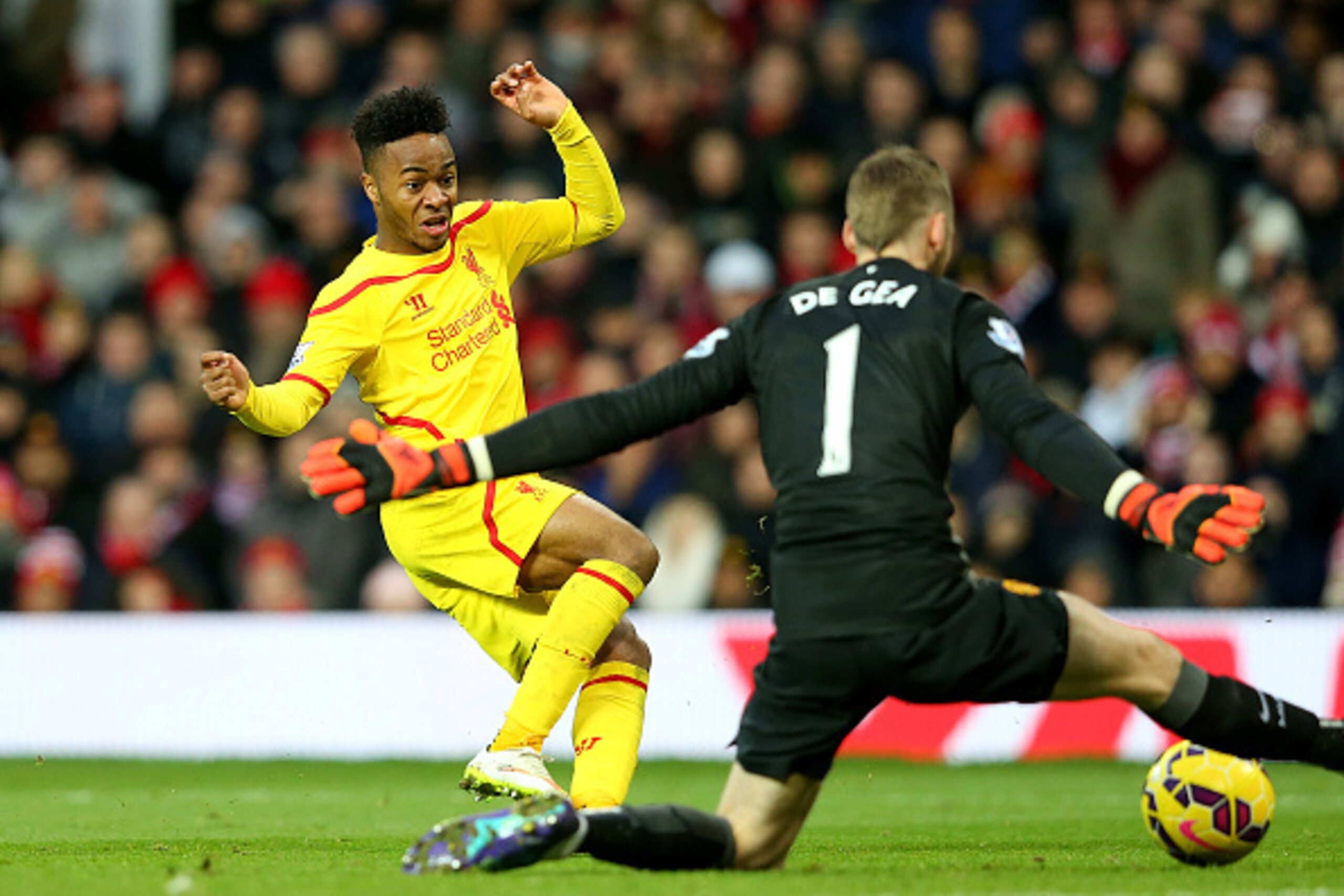 MANCHESTER, ENGLAND - DECEMBER 14: Dvid De Gea of Manchester United saves the attempt on goal of Raheem Sterling of Liverpool in a one on one situation during the Barclays Premier League match between Manchester United and Liverpool at Old Trafford on De MANCHESTER, ENGLAND - DECEMBER 14: Dvid De Gea of Manchester United saves the attempt on goal of Raheem Sterling of Liverpool in a one on one situation during the Barclays Premier League match between Manchester United and Liverpool at Old Trafford on De