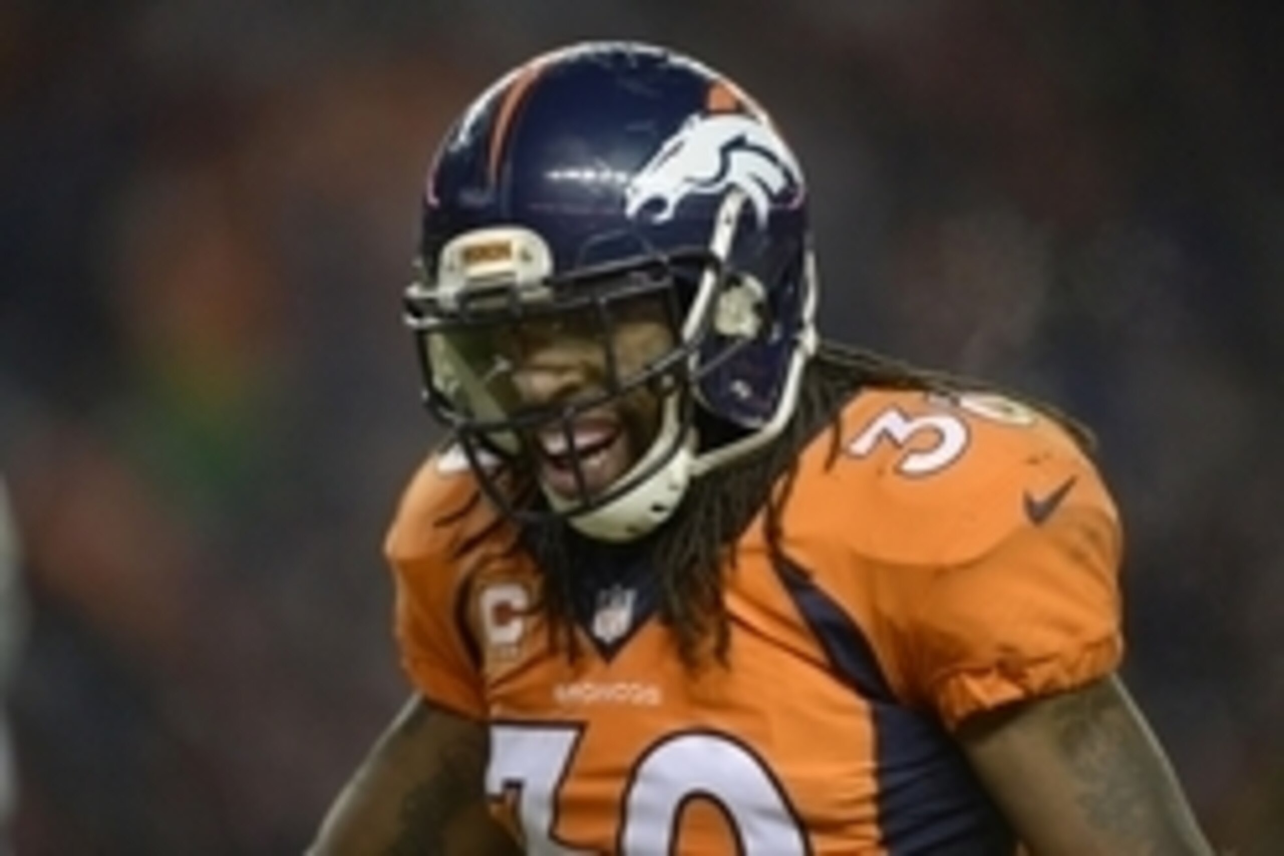 Dec 28, 2014; Denver, CO, USA; Denver Broncos strong safety David Bruton (30) reacts to a tackle in the fourth quarter against the Oakland Raiders at Sports Authority Field at Mile High. The Broncos defeated the Raiders 40-14. Mandatory Credit: Ron Chenoy