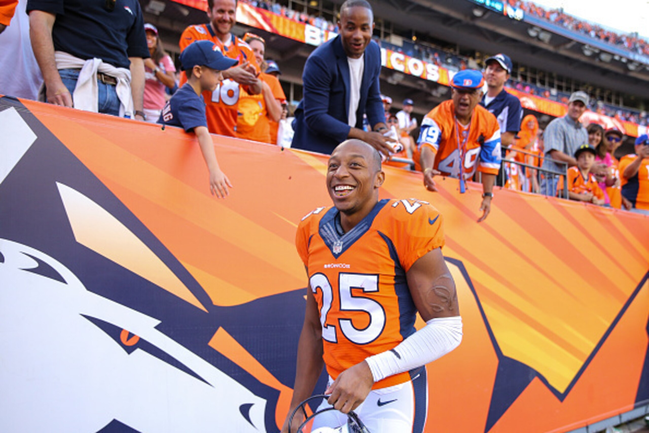 DENVER, CO - OCTOBER 5:  Cornerback Chris Harris #25 of the Denver Broncos smiles as he greets fans after a win over the Arizona Cardinals at Sports Authority Field at Mile High on October 5, 2014 in Denver, Colorado.  (Photo by Justin Edmonds/Getty Image
